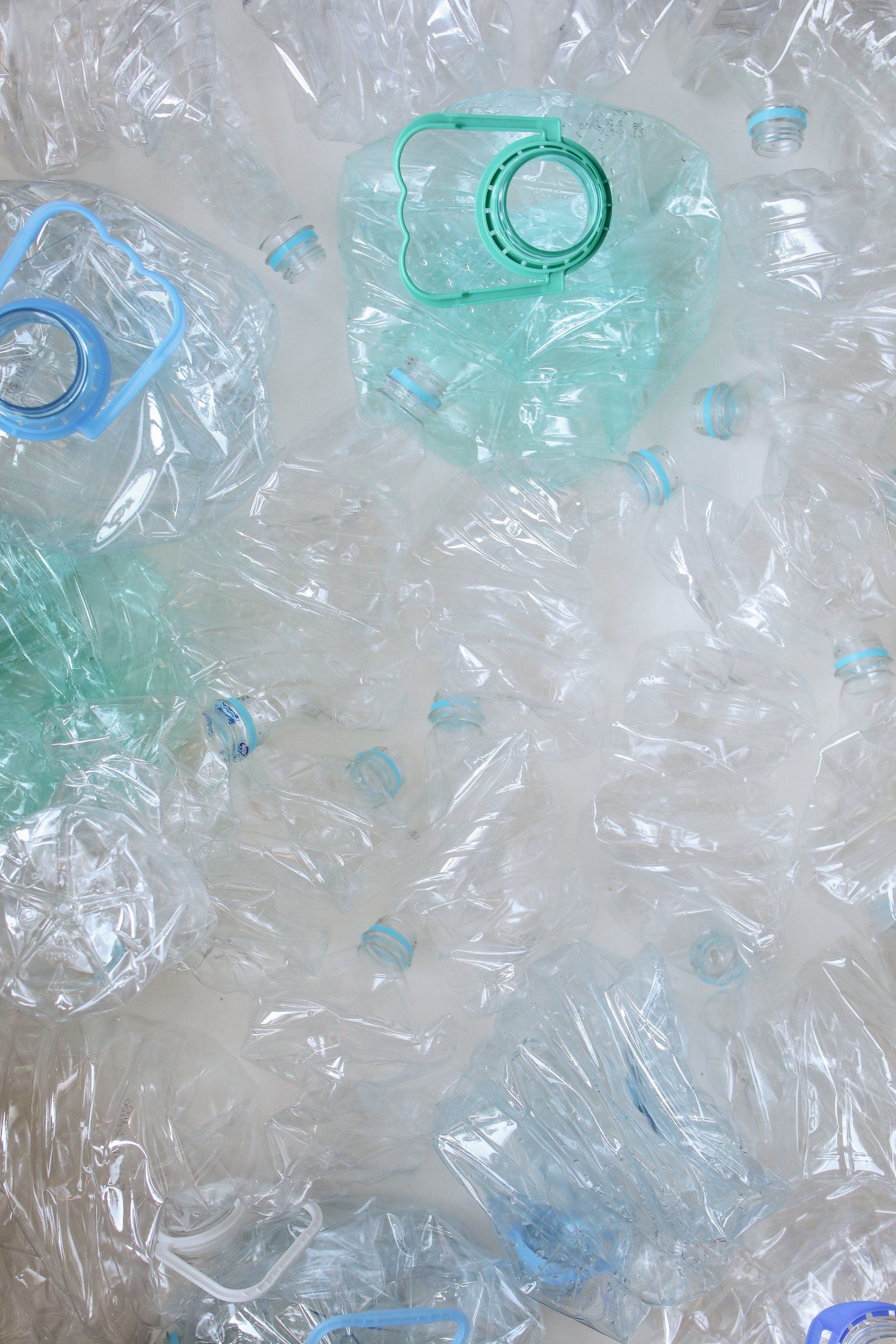 A pile of plastic bottles wrapped in plastic wrap.