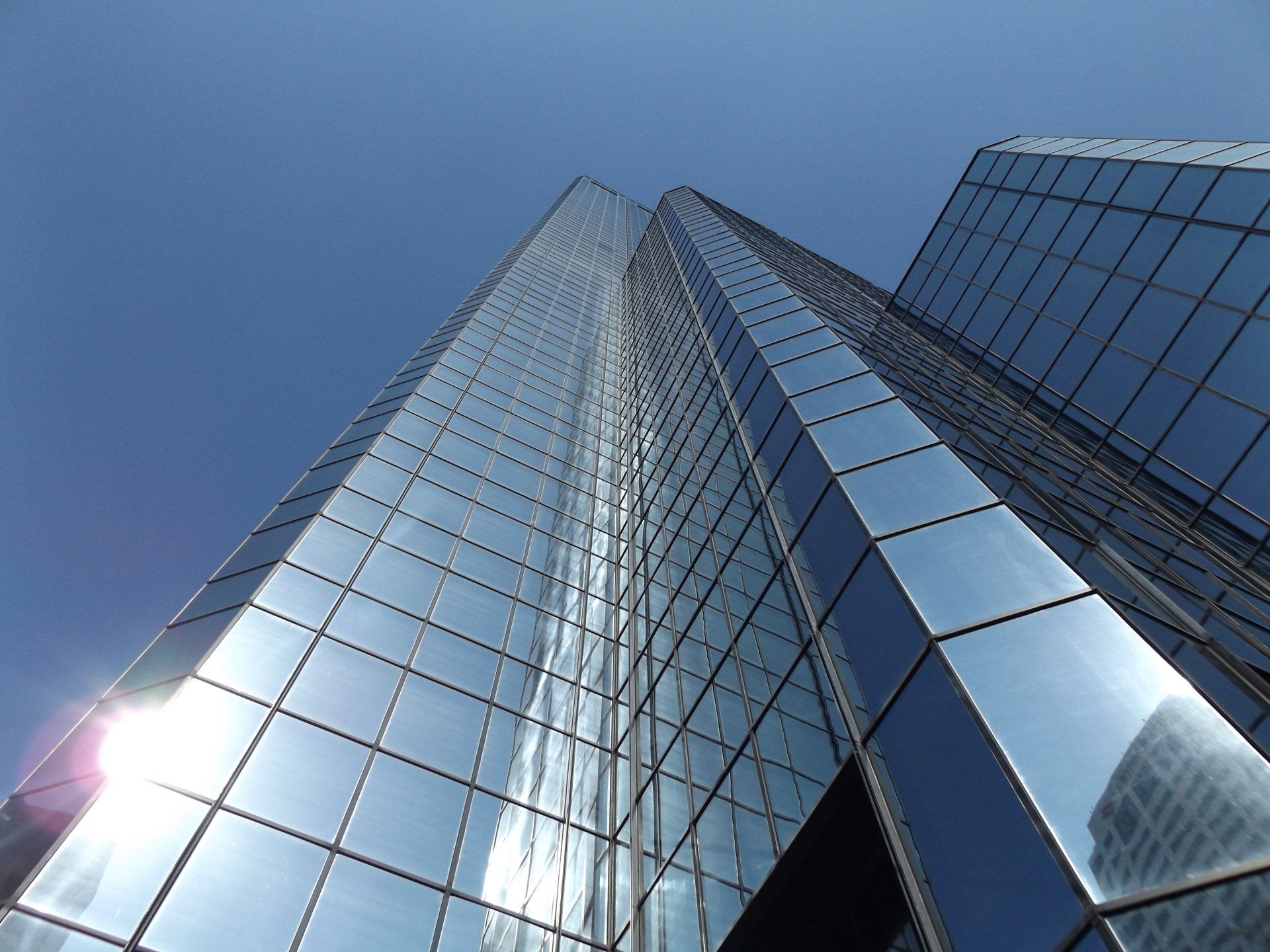 A glass-and-steel skyscraper, viewed from the ground floor