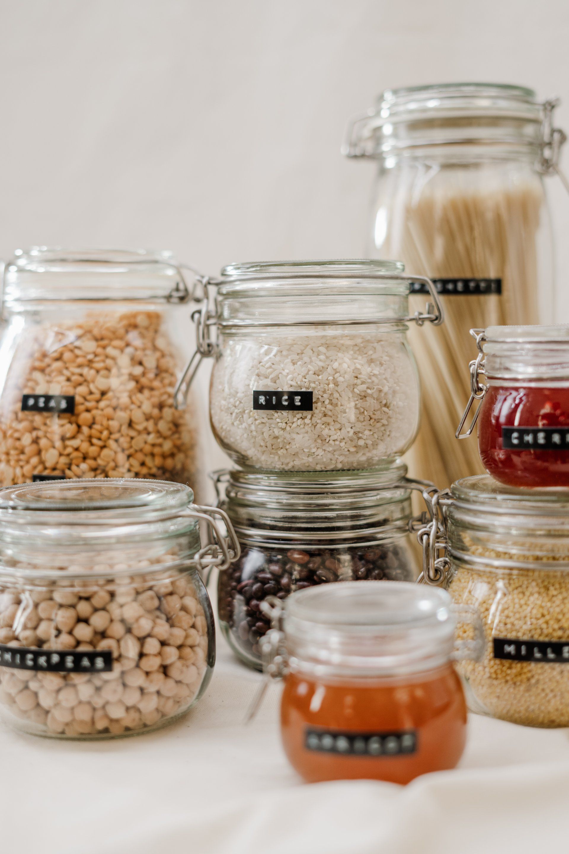 A table topped with jars filled with different types of food.