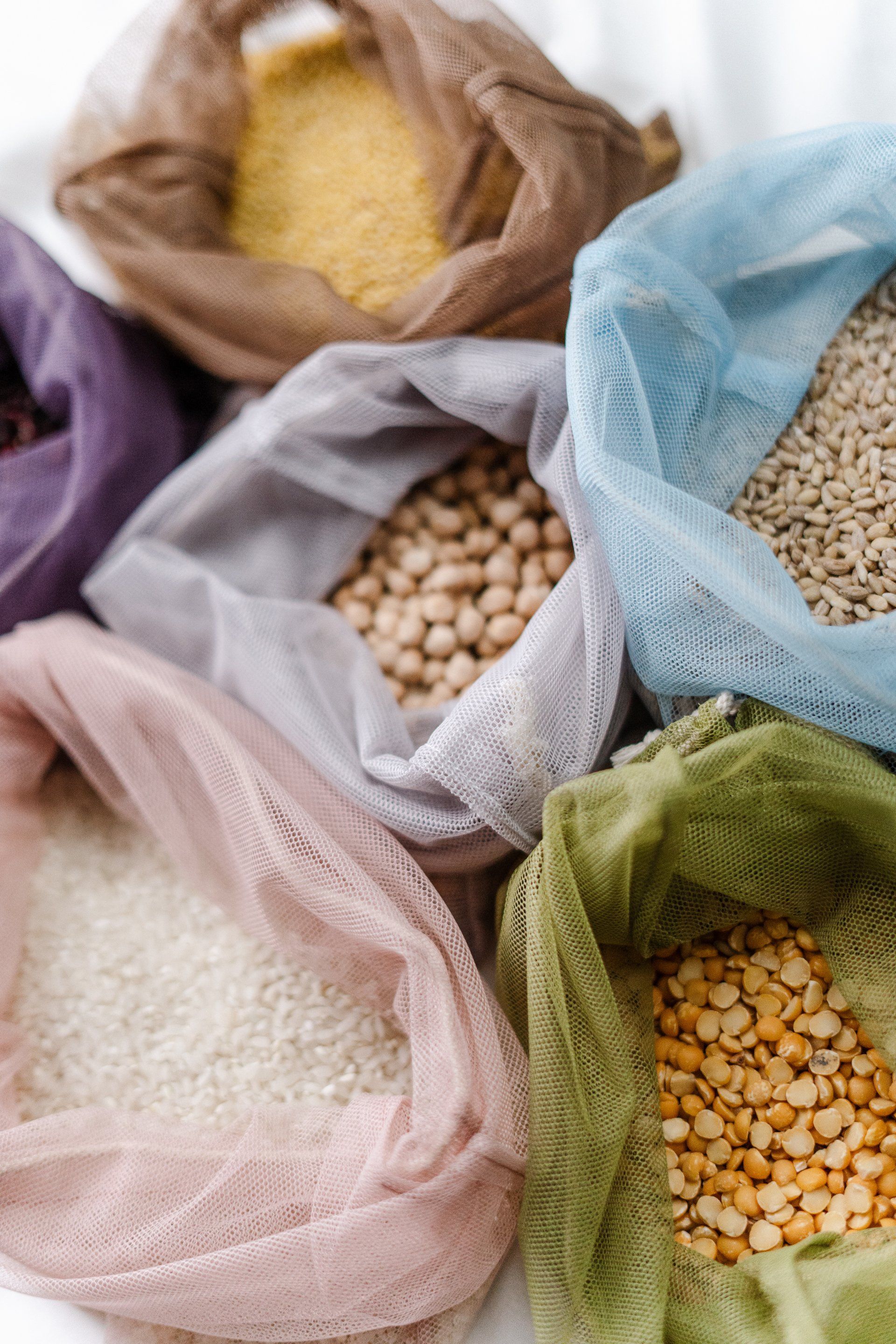 A bunch of bags filled with different types of grains and beans.