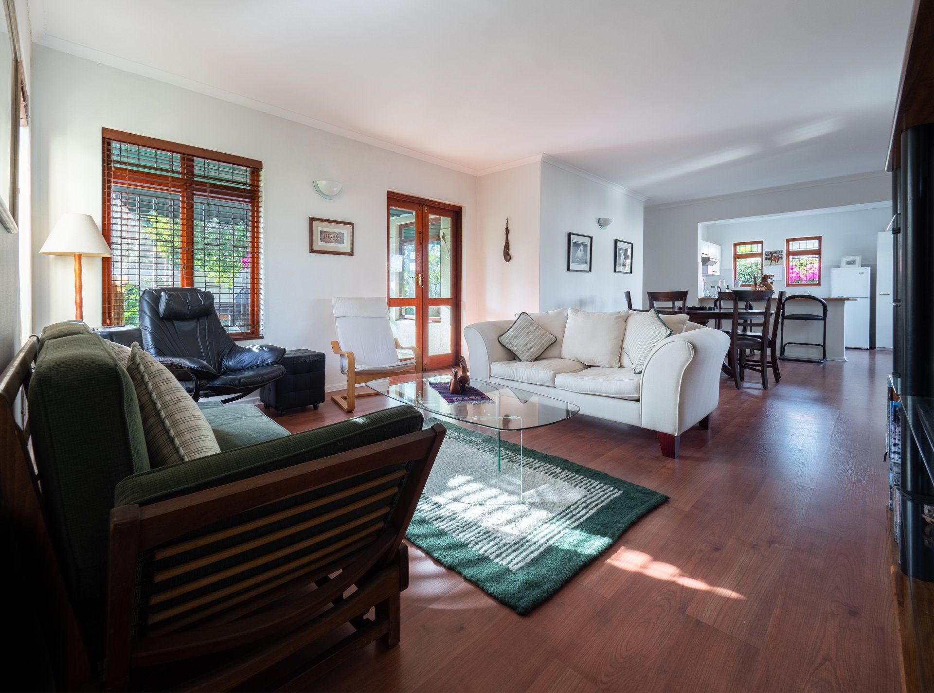 A living room with a couch , chair and rug