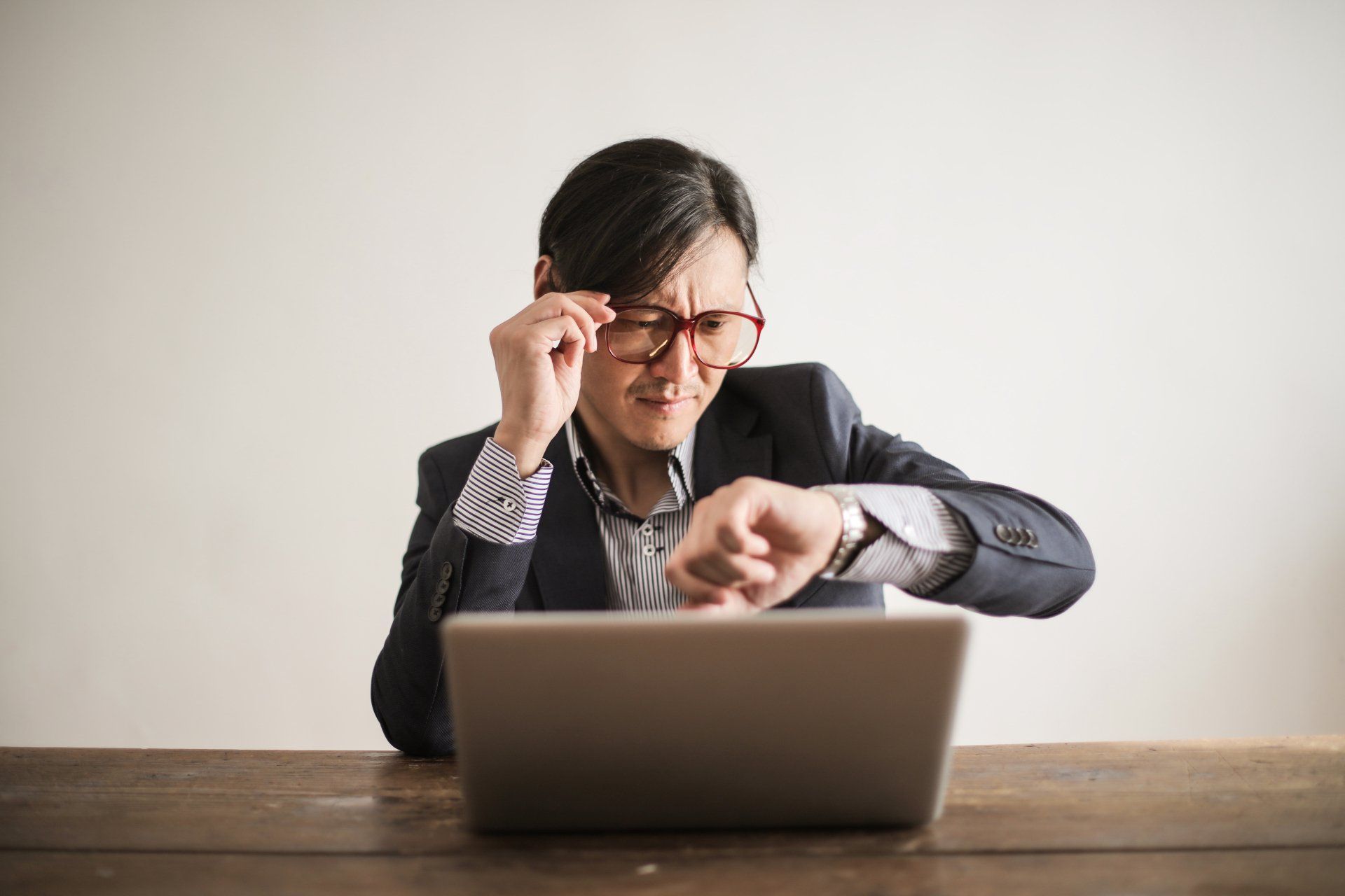 a man sitting in front of a laptop worried about missing tax deadline