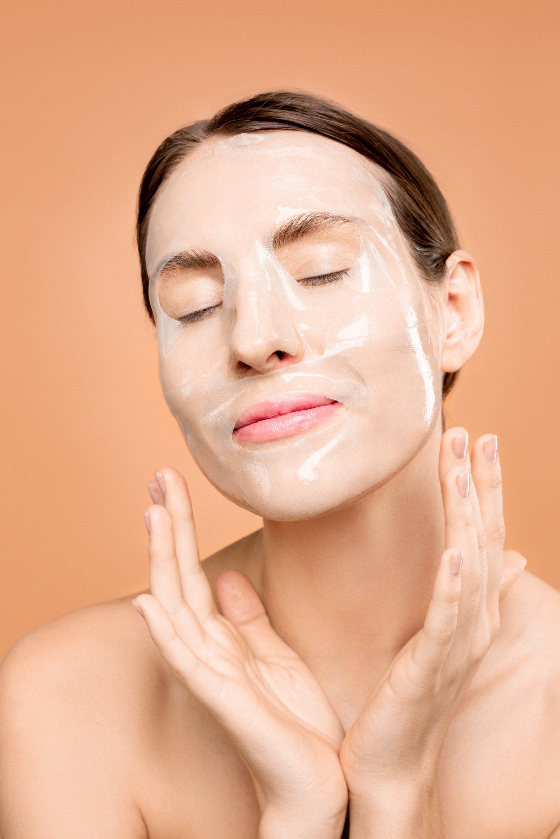 A woman is wearing a white mask on her face.