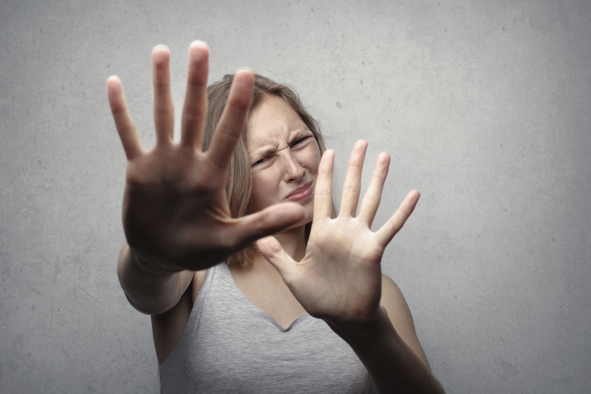 Woman holding her hands out as if saying back off