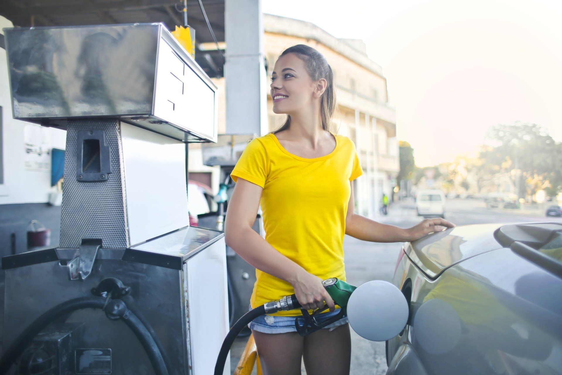 a woman recharging fuel to a vehicle