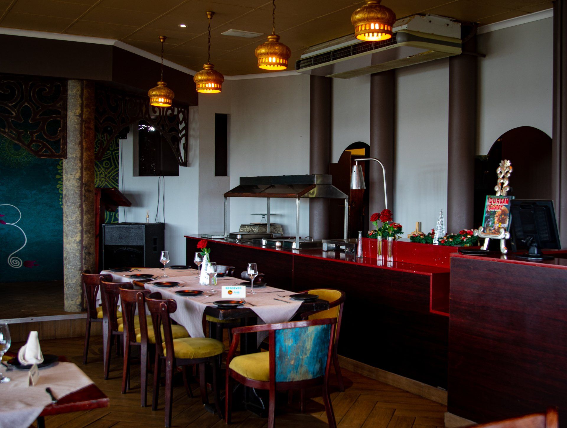 A restaurant with tables and chairs and a buffet