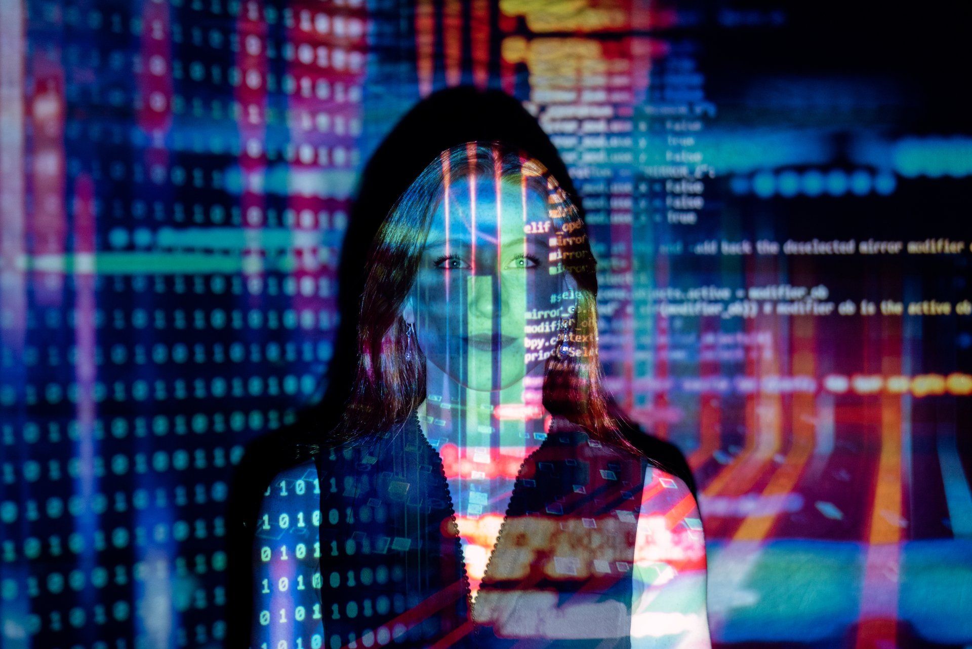 a woman is standing in front of a screen with binary code on it