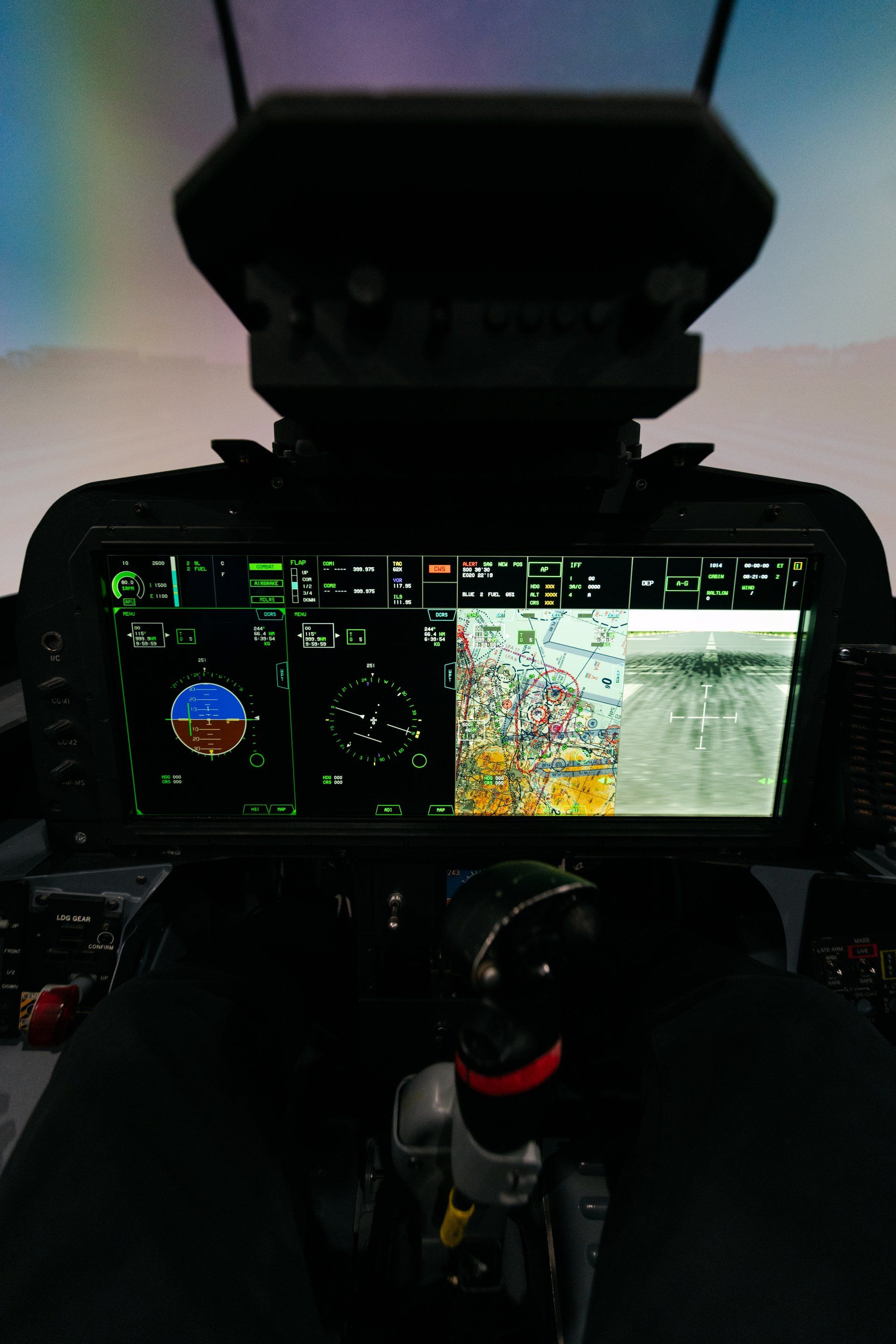 A cockpit of a fighter jet with a rainbow in the background