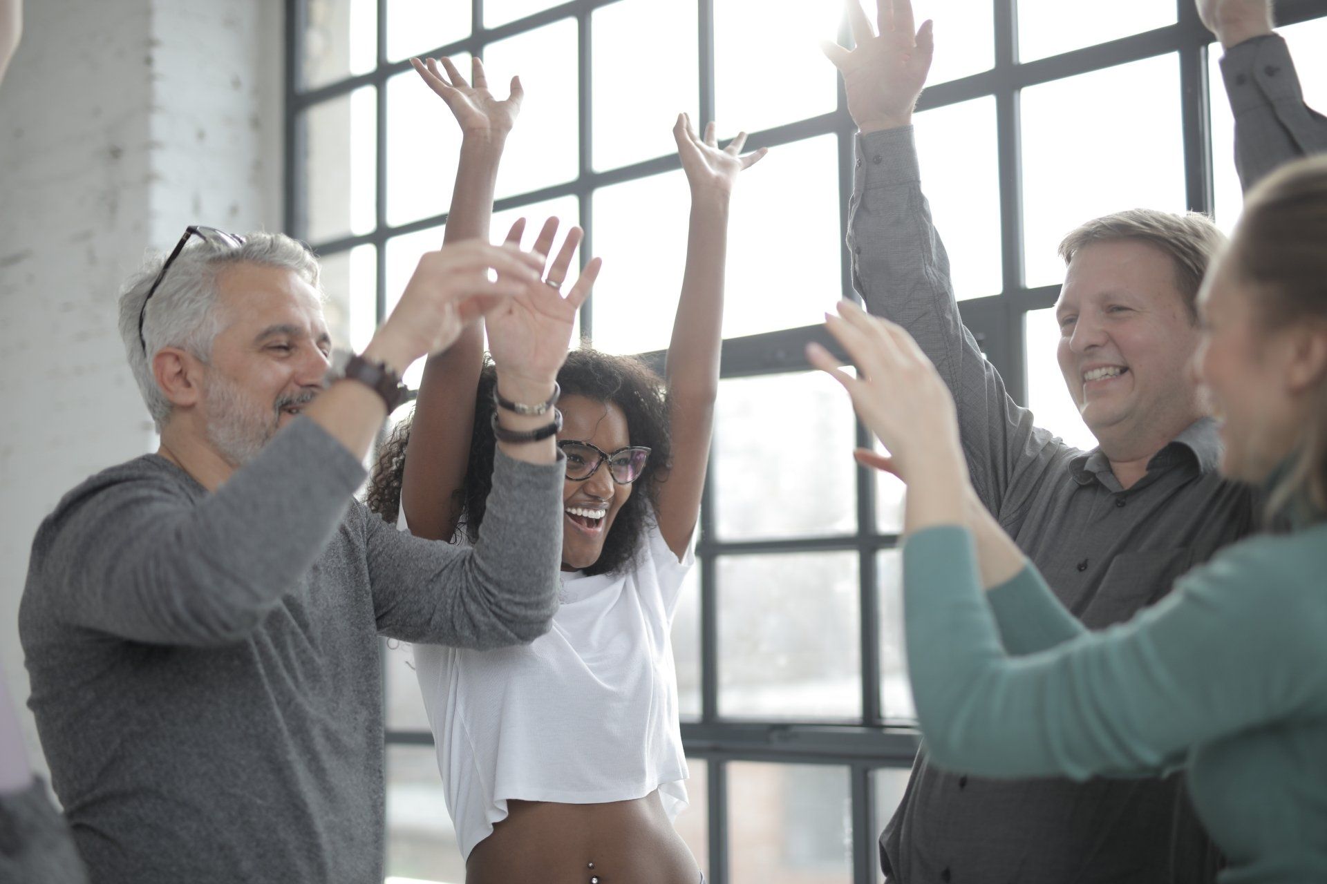 A group of people are giving each other a high five.