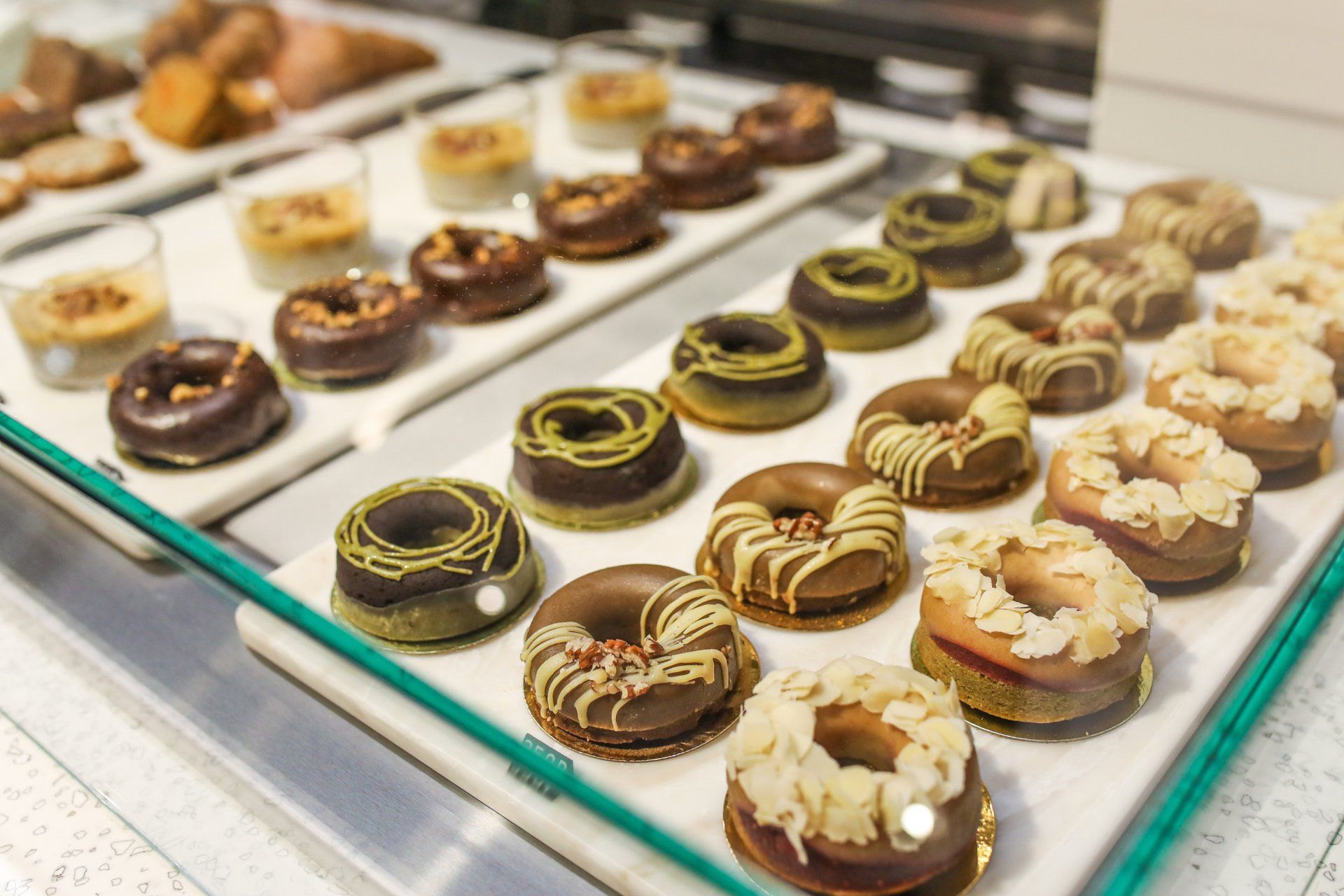 A display case filled with lots of different types of donuts.