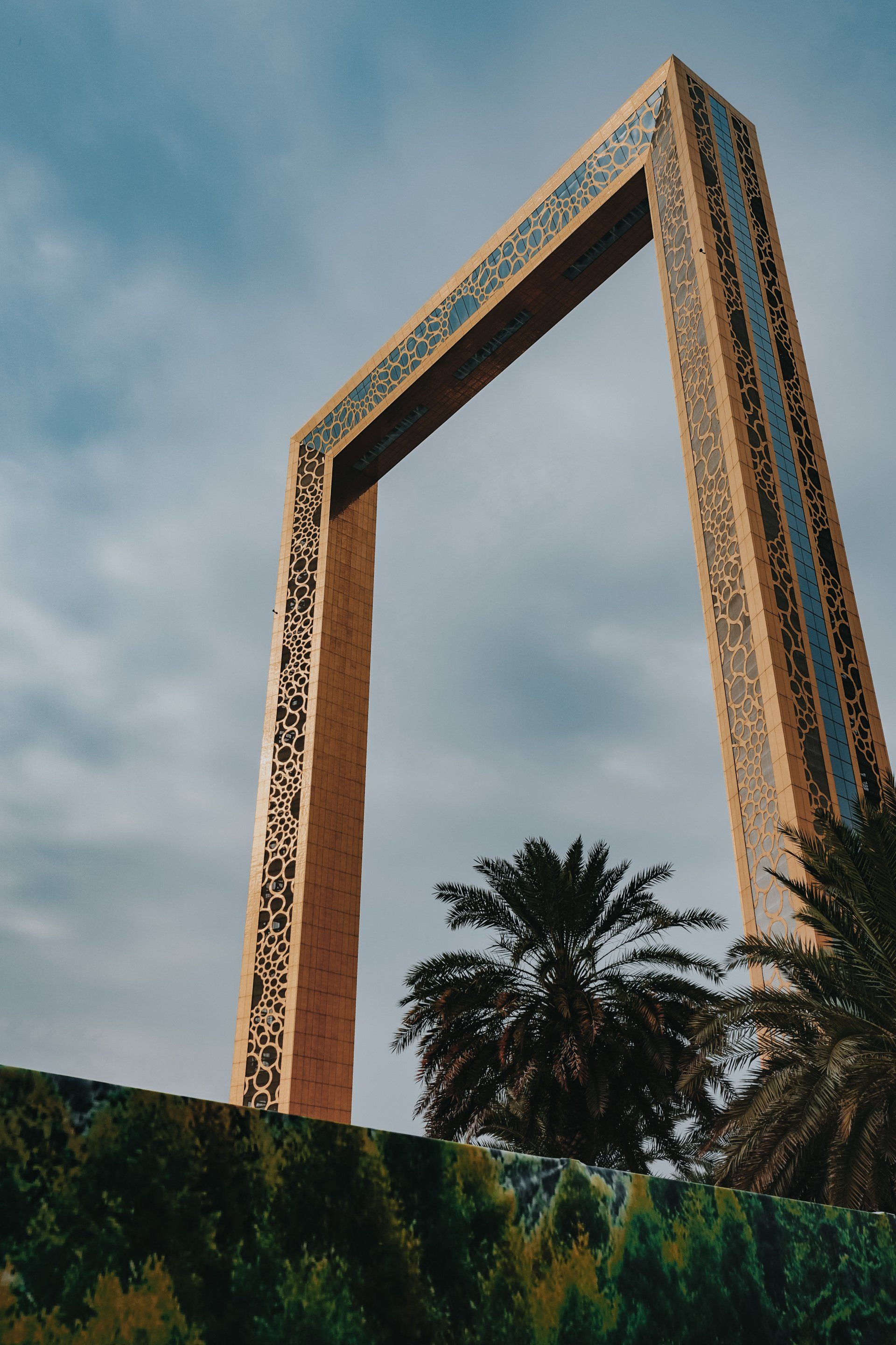 A very tall building with a palm tree in front of it