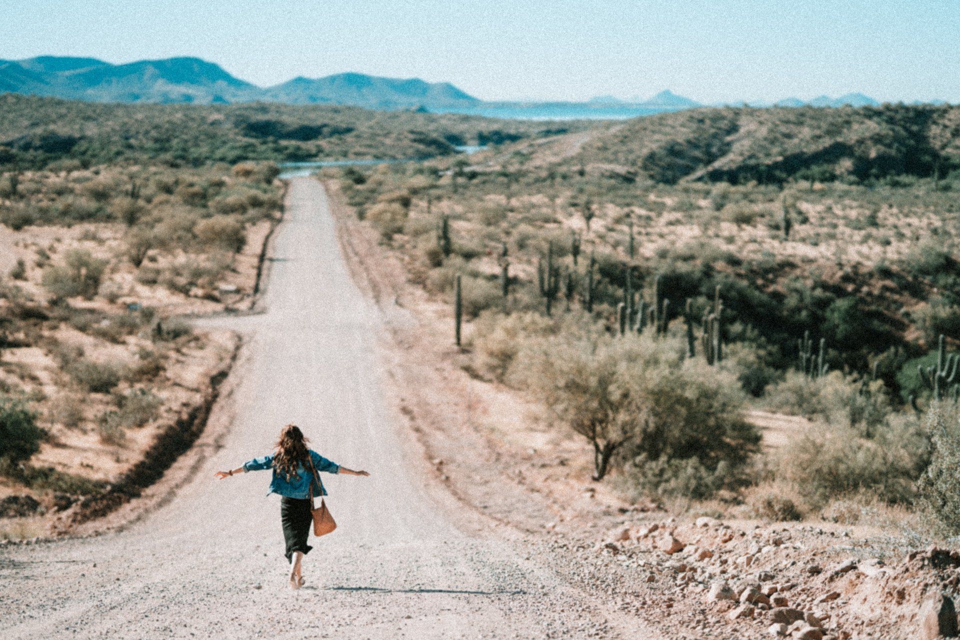 girl running down a dirt road