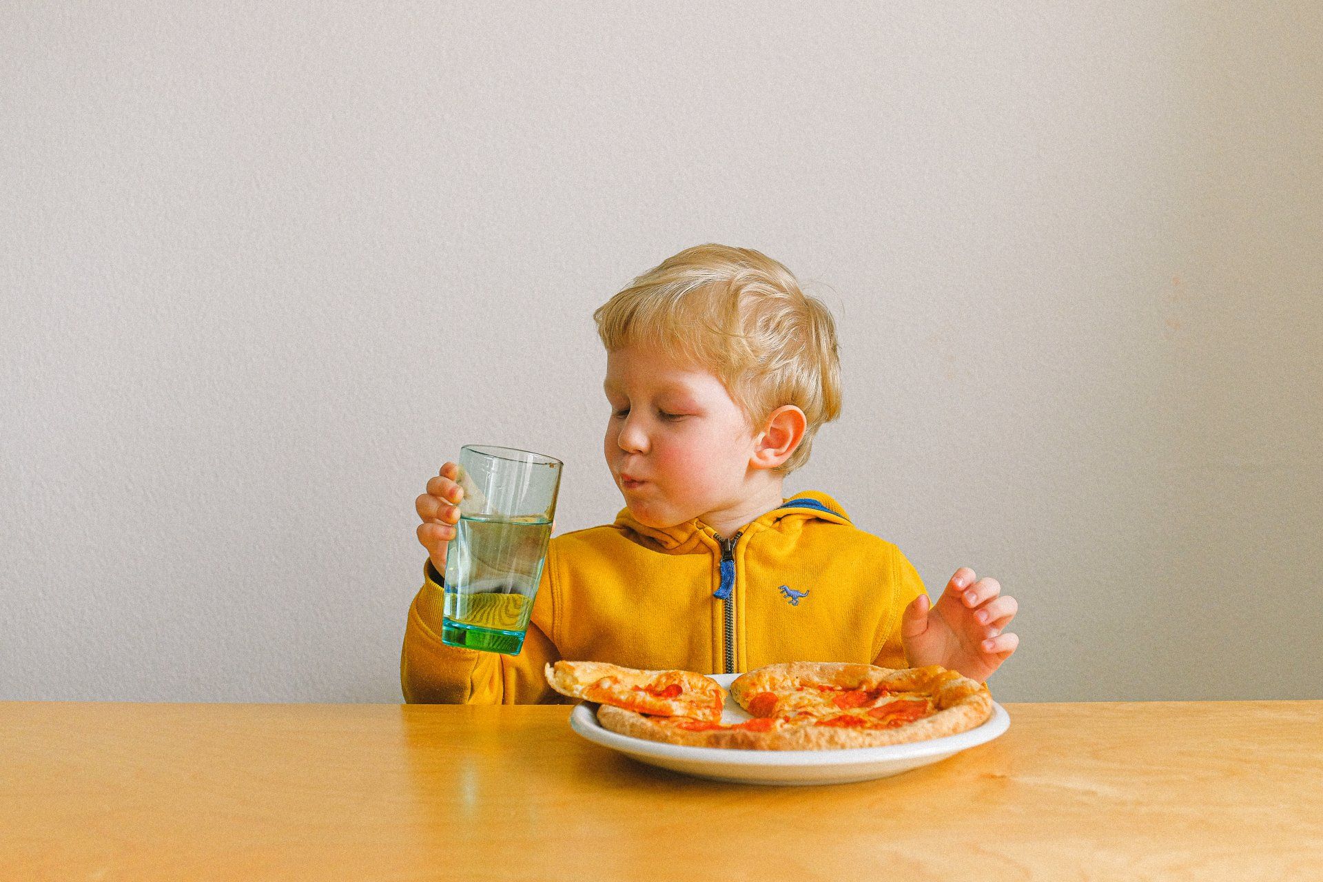 Toddler boy eating pizza