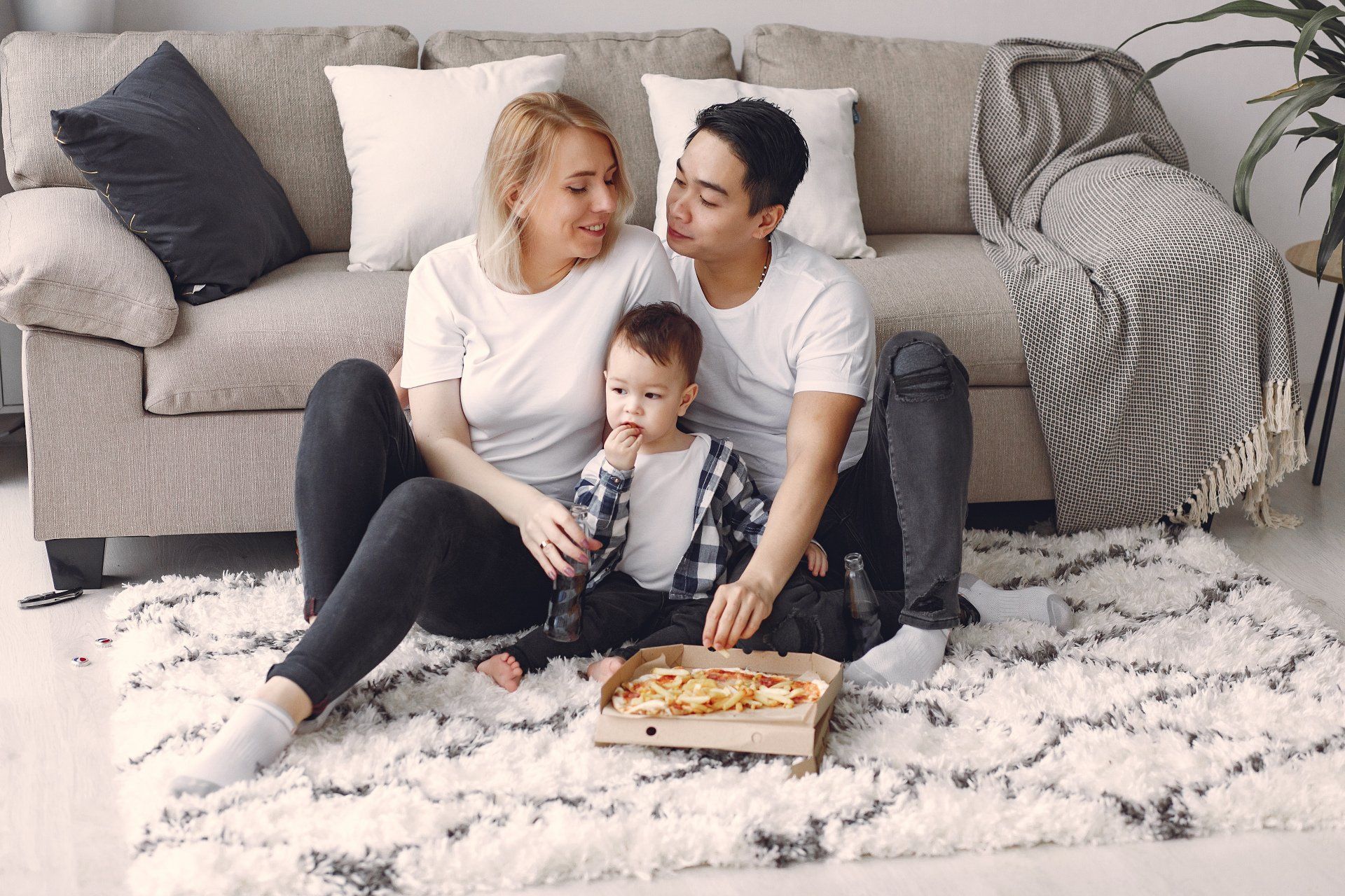 a family sitting on a carpet