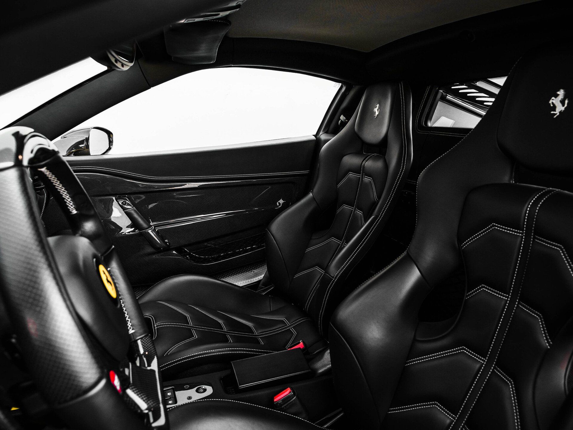 Interior view of a modern black car featuring comfortable leather seats.