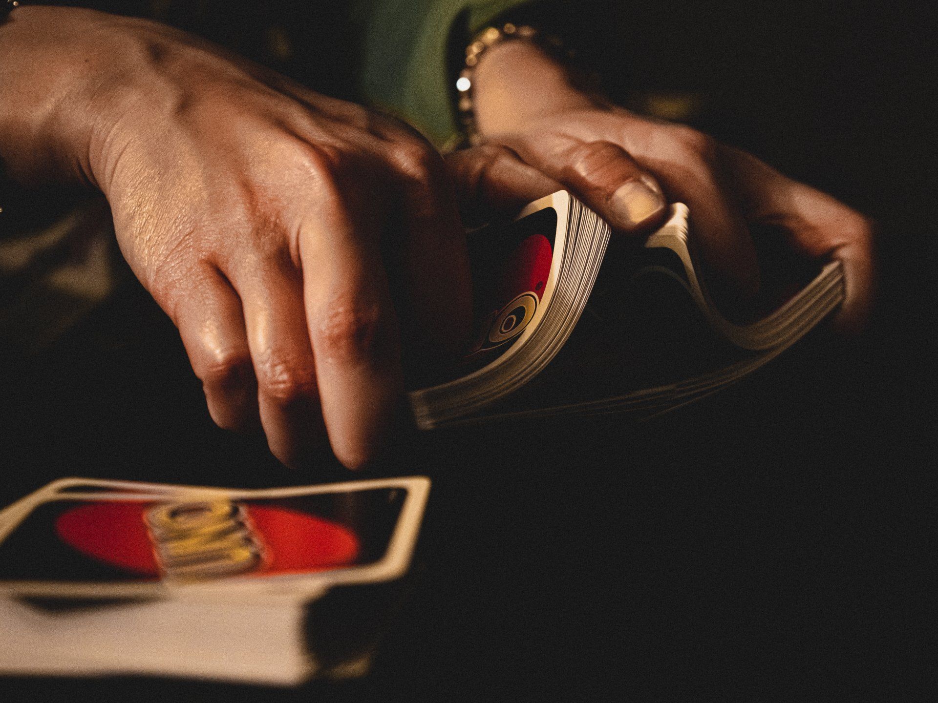 A close up of a person playing uno cards