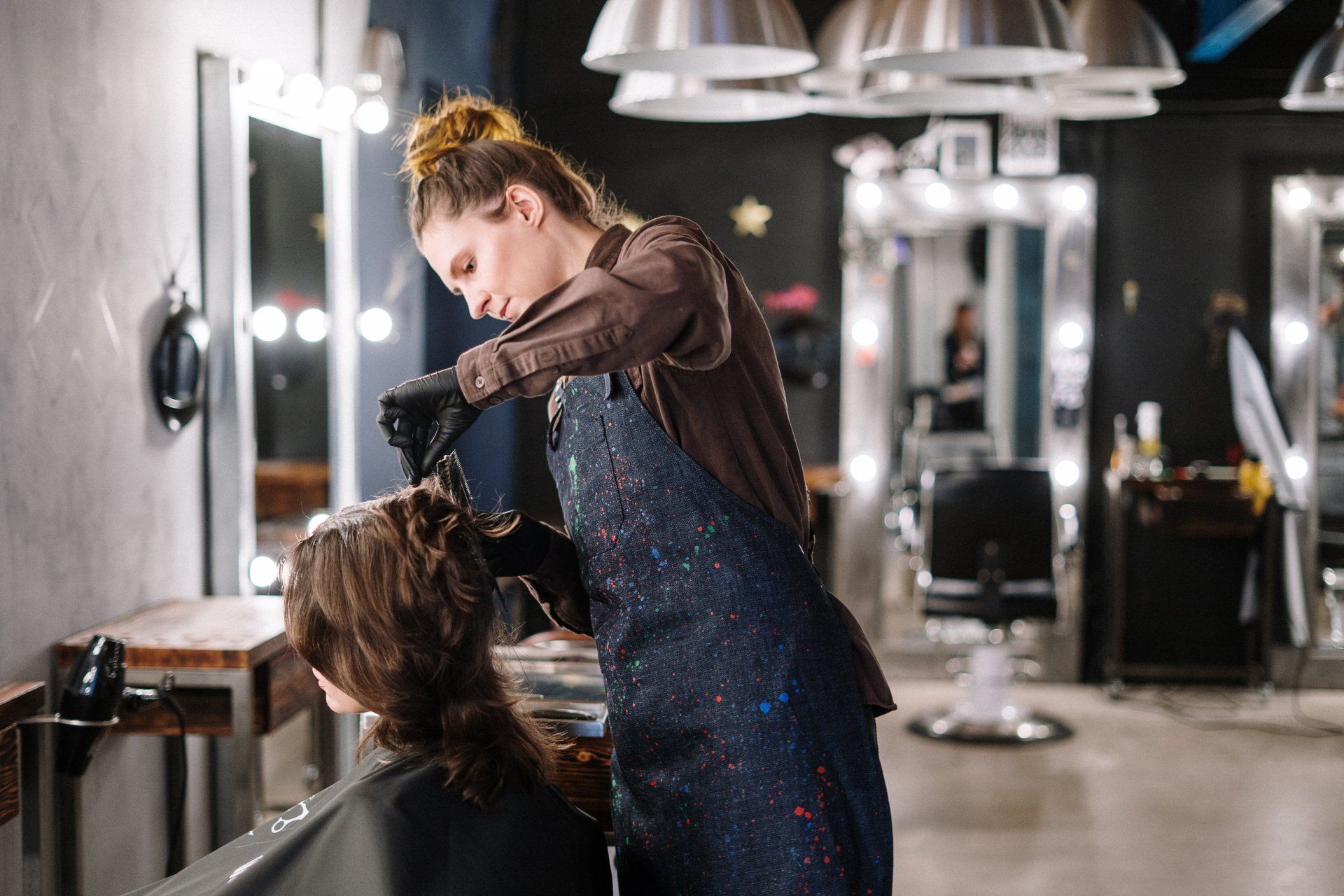a woman is getting her hair blow dried by a hairdresser in a salon .