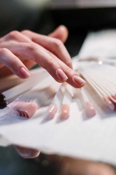 A close up of a person 's hands holding a fan.