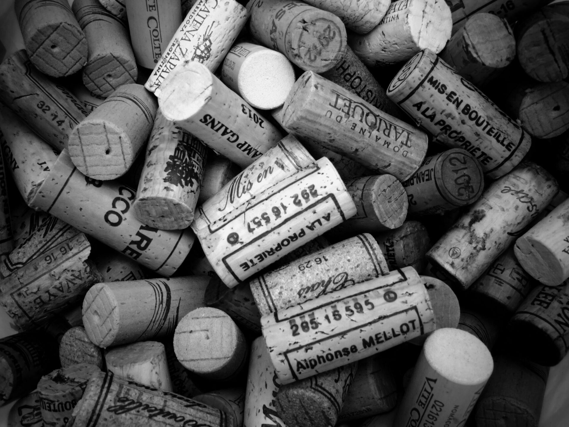 A black and white photo of a pile of wine corks