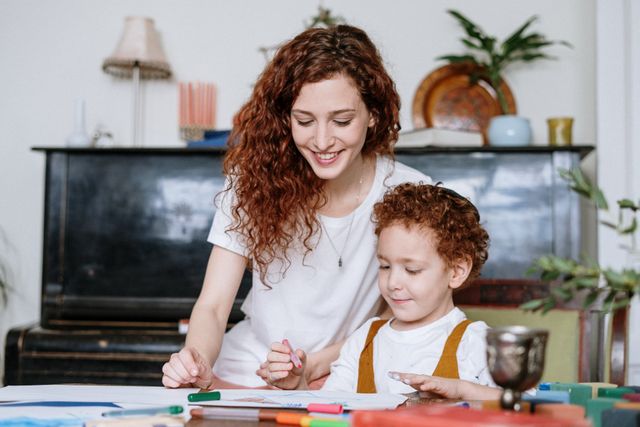 A woman and a child are sitting at a table.