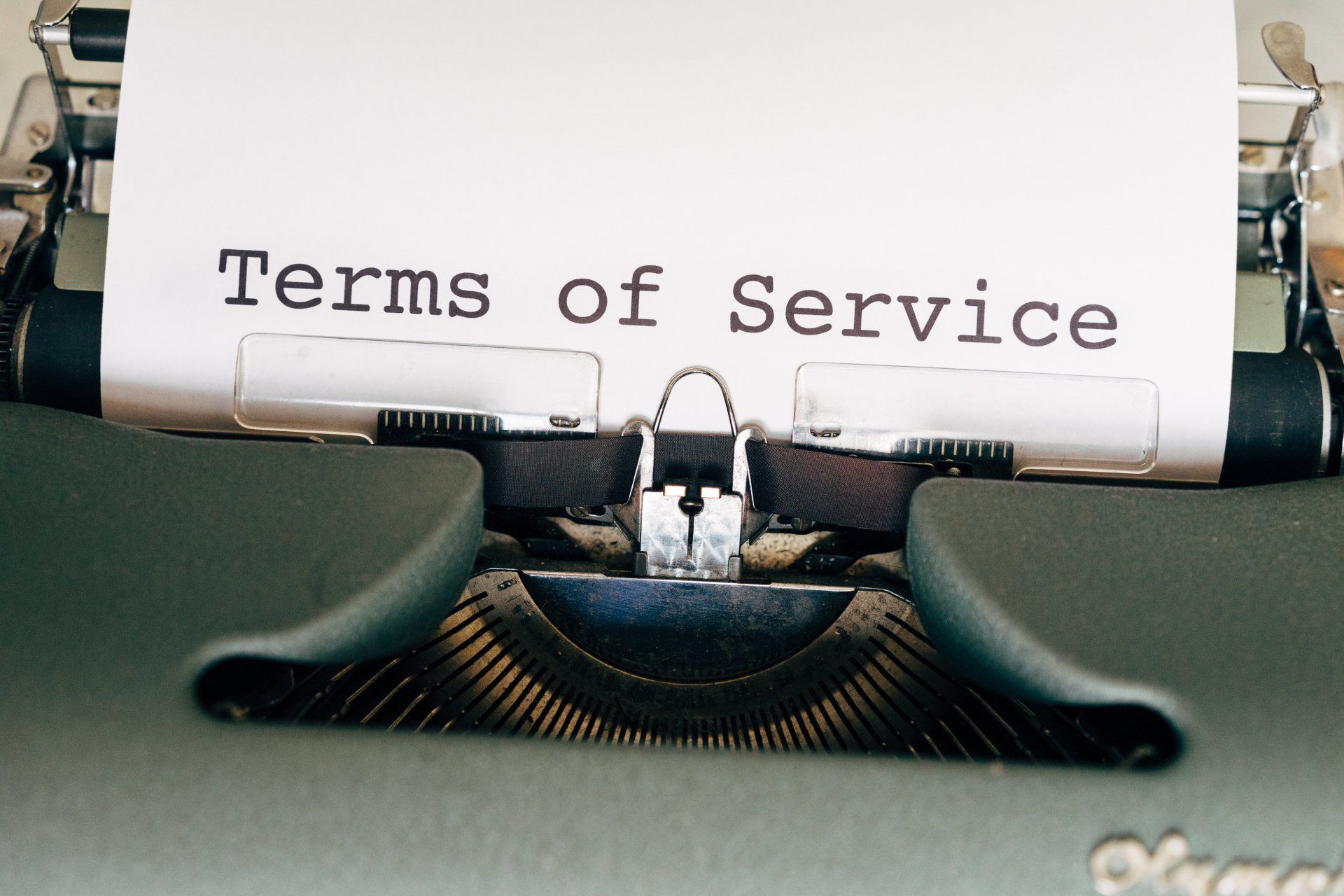 a typewriter with a piece of paper that says terms of service