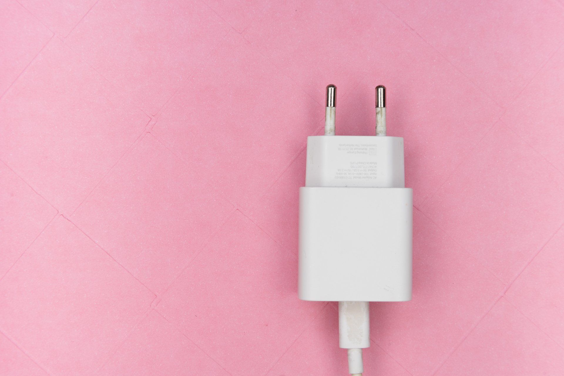 Plug against a pink background