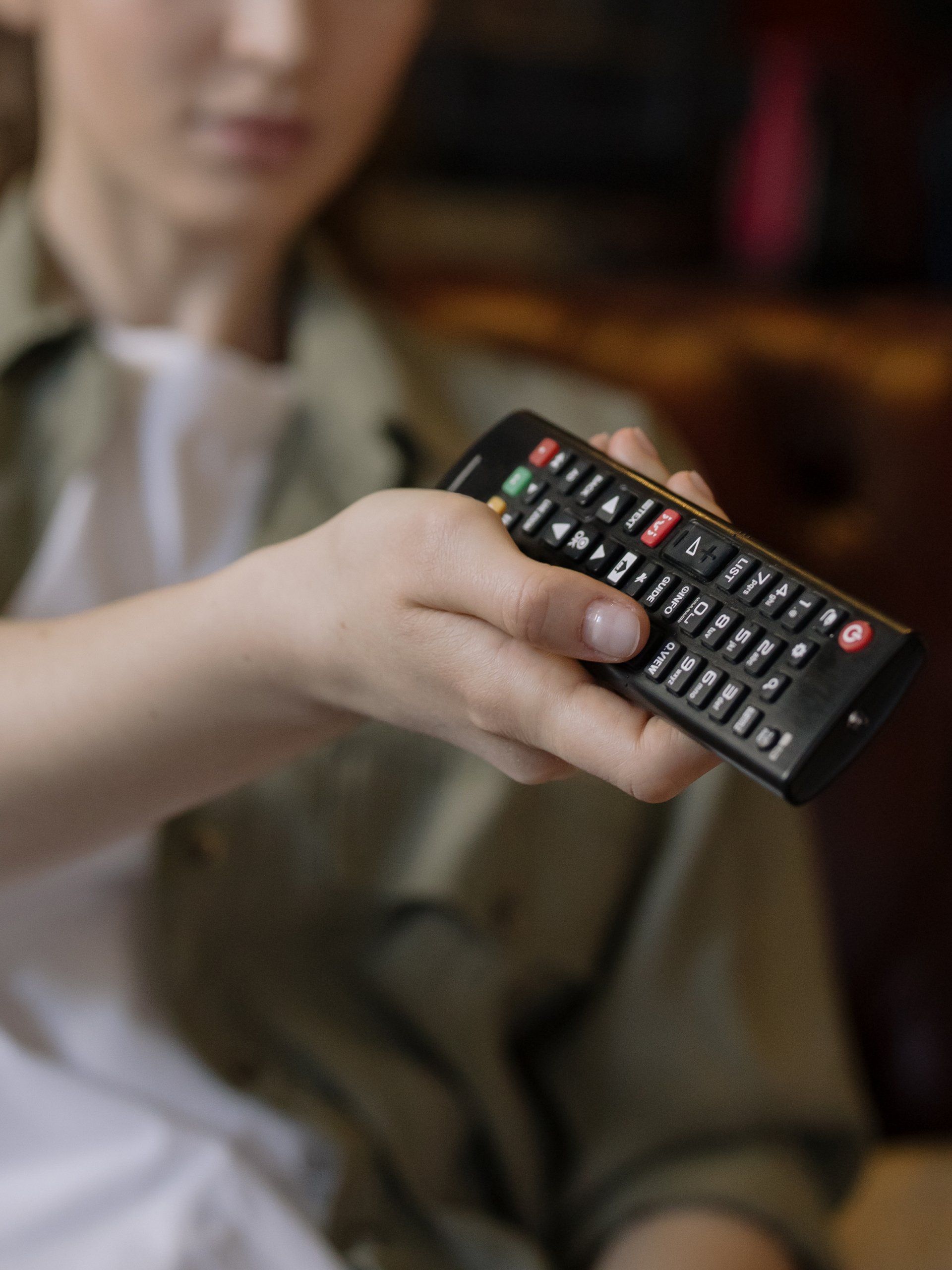 A person is holding a remote control in their hand