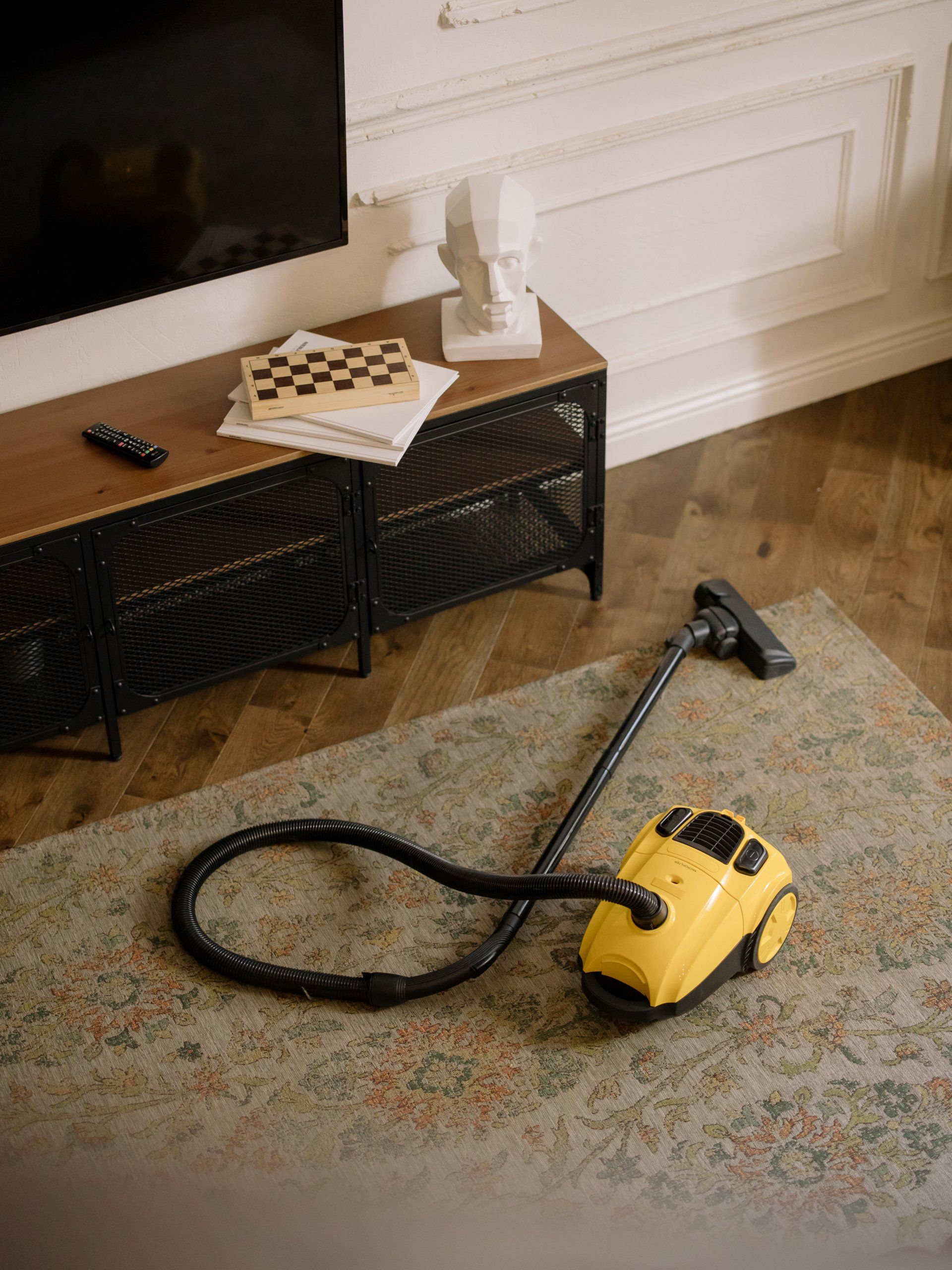 Cleaning the carpet with vacuum cleaner