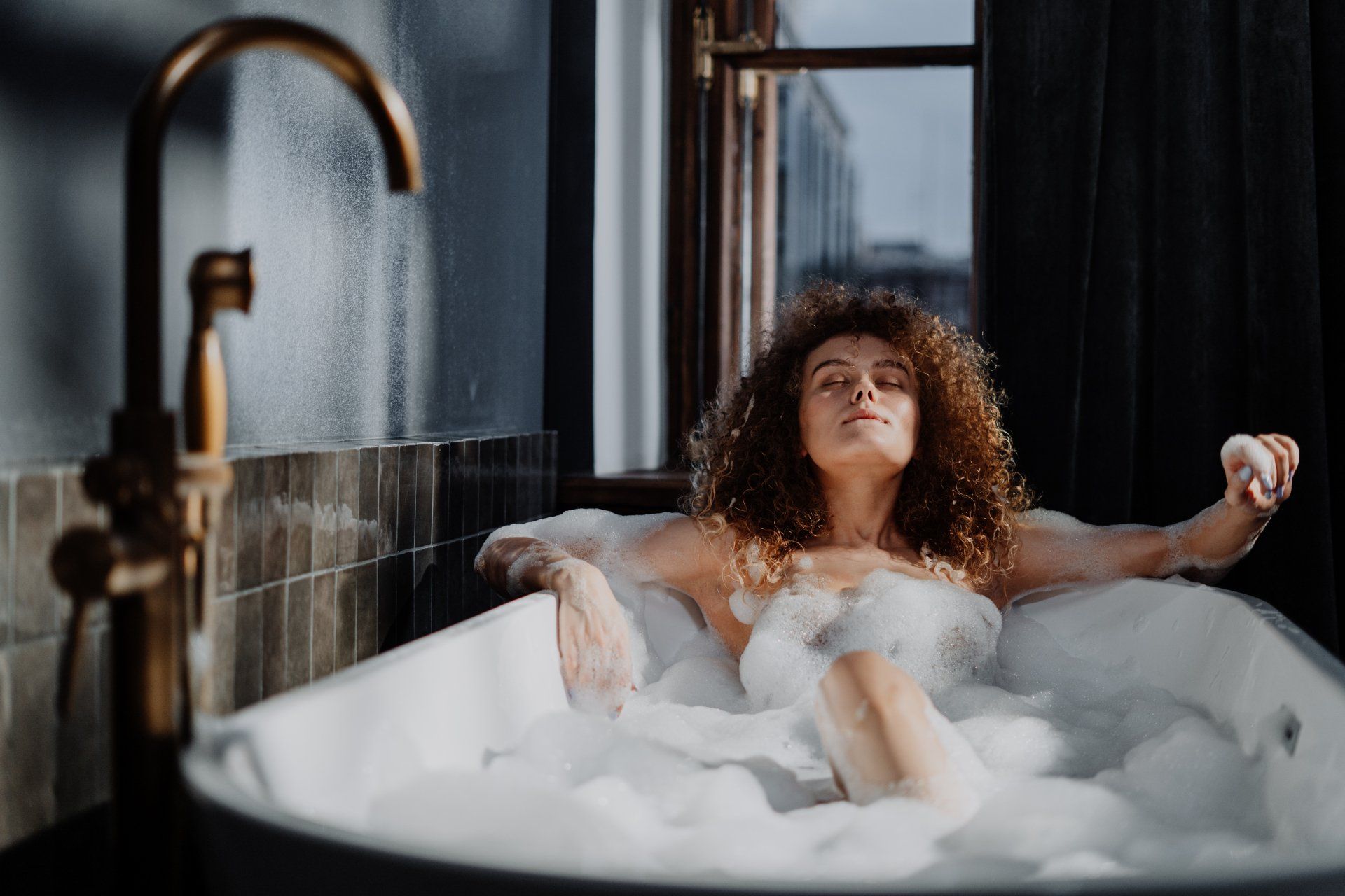 a woman is taking a bath in a bathtub filled with foam: 10 Smart Bathroom Renovation Ideas to Elevate Your Home in 2024.