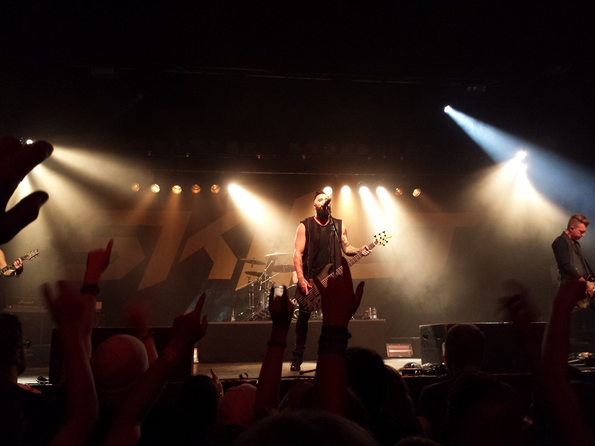 A man is playing a guitar on stage in front of a crowd