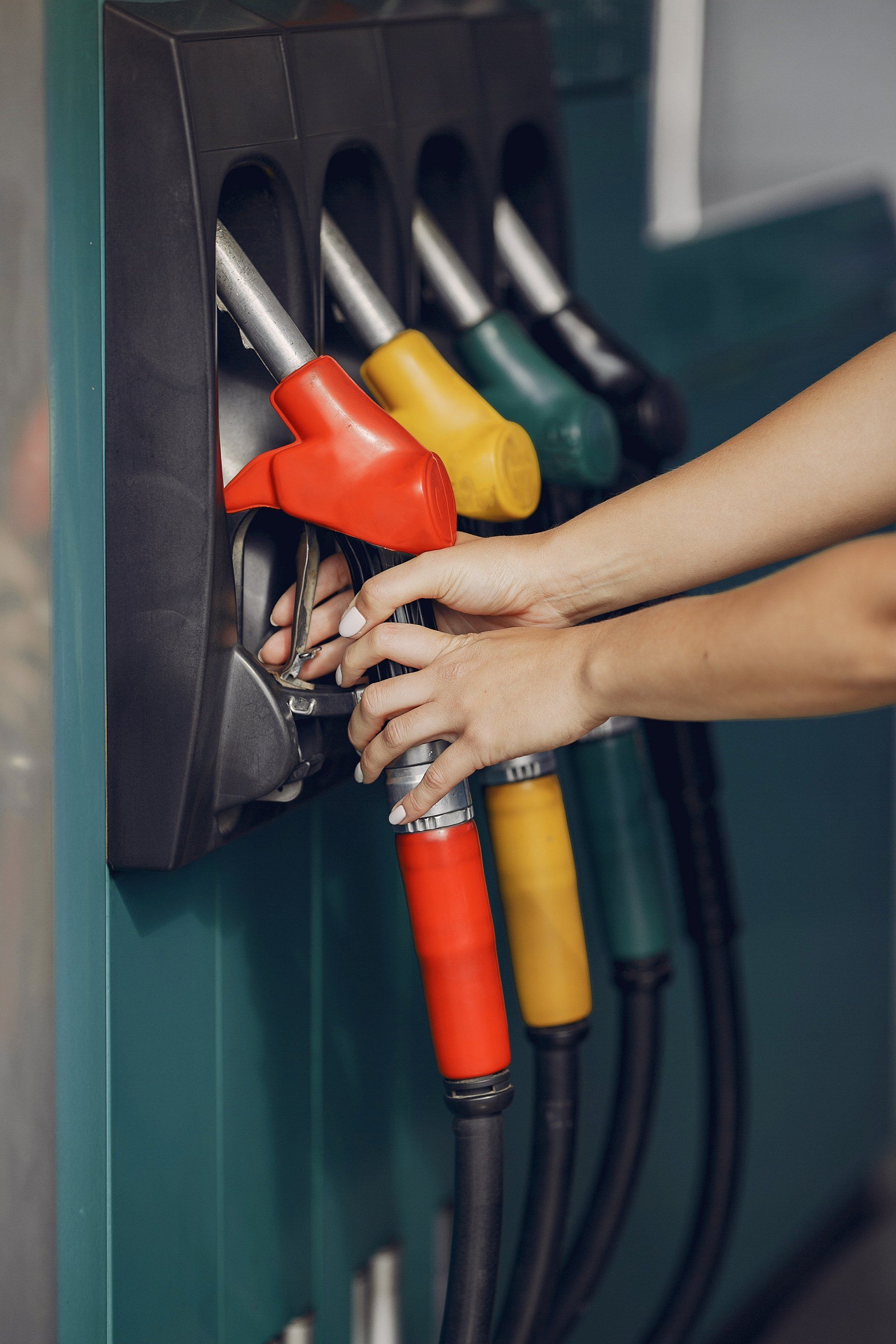 Hands holding a fuel pump