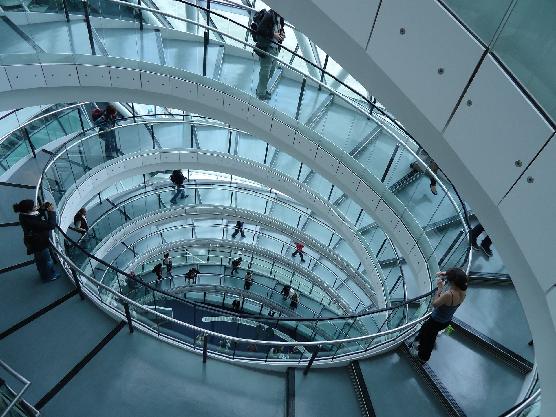 A winding staircase with a few people on it