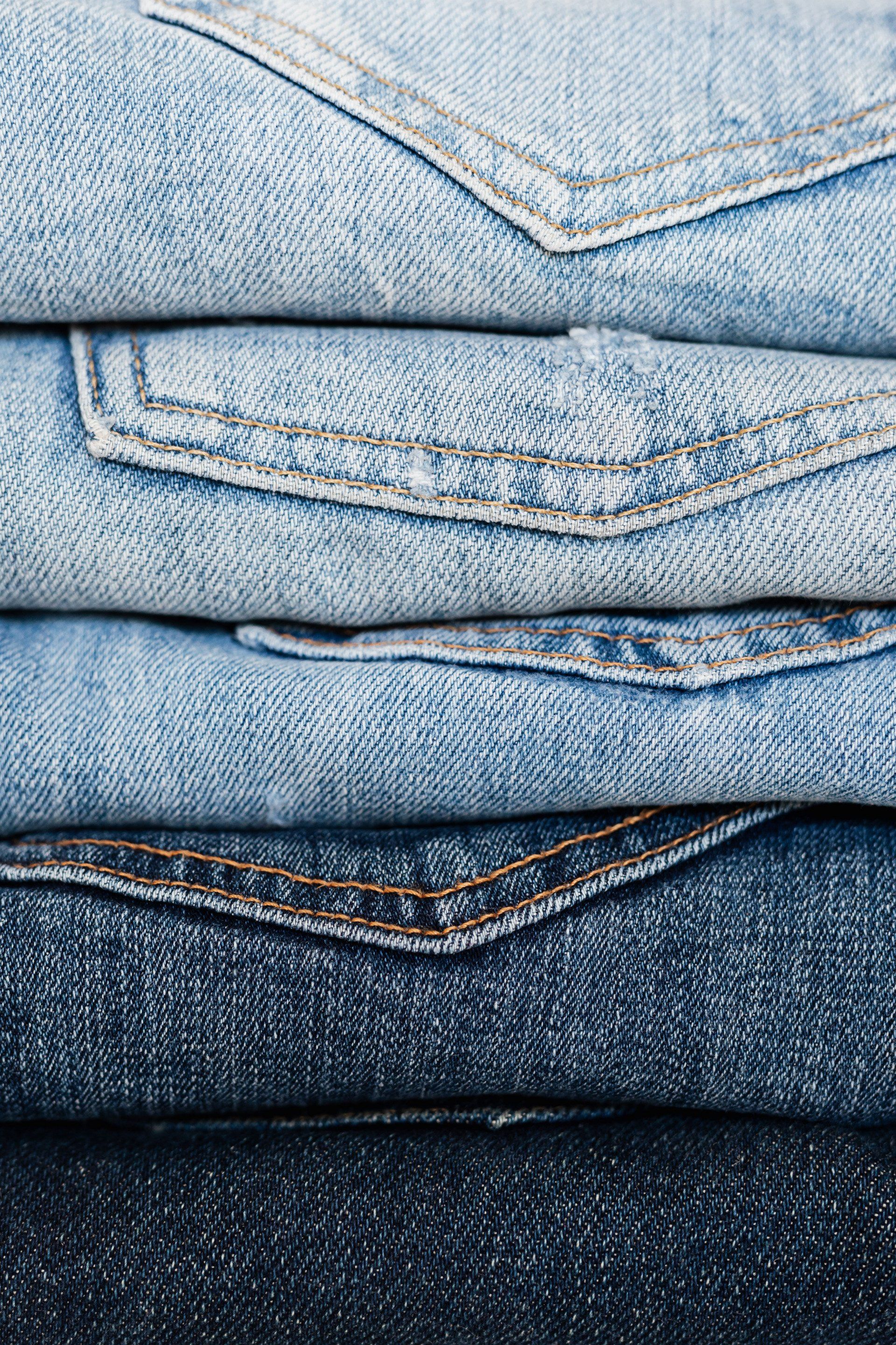 A close up of a stack of blue jeans.