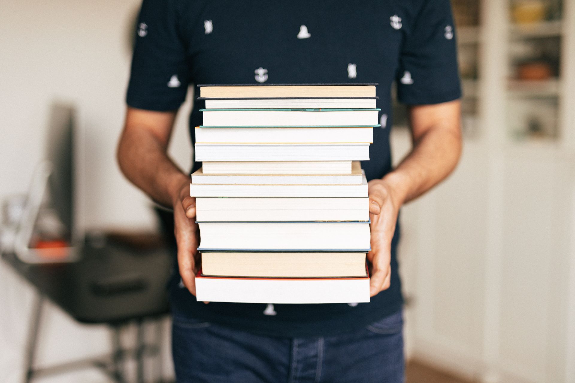 Image of a client holding a stack of published books