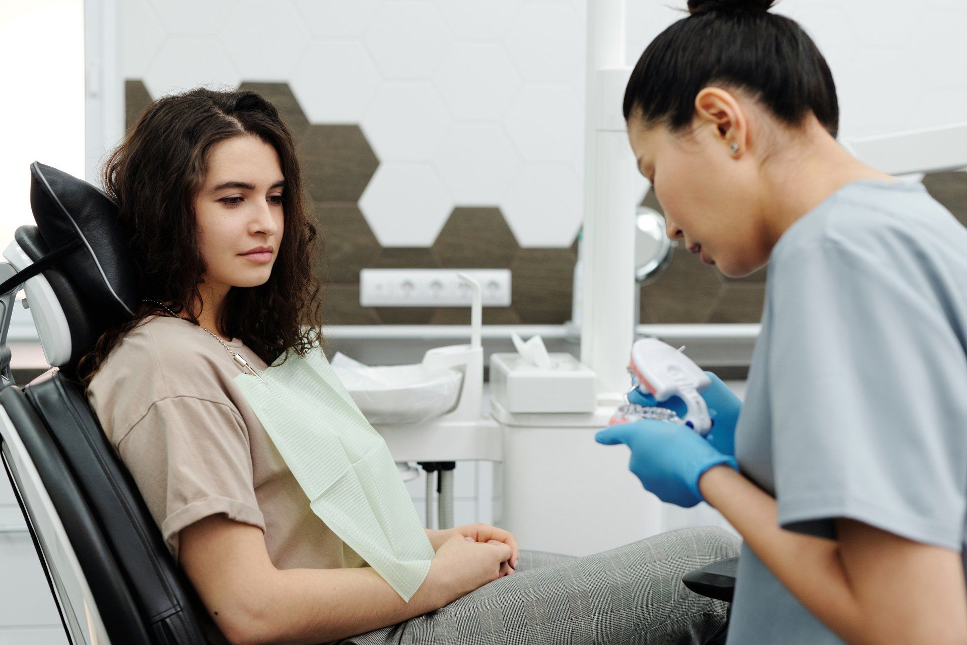 woman looking at dentist | Wisdom Tooth Extractions