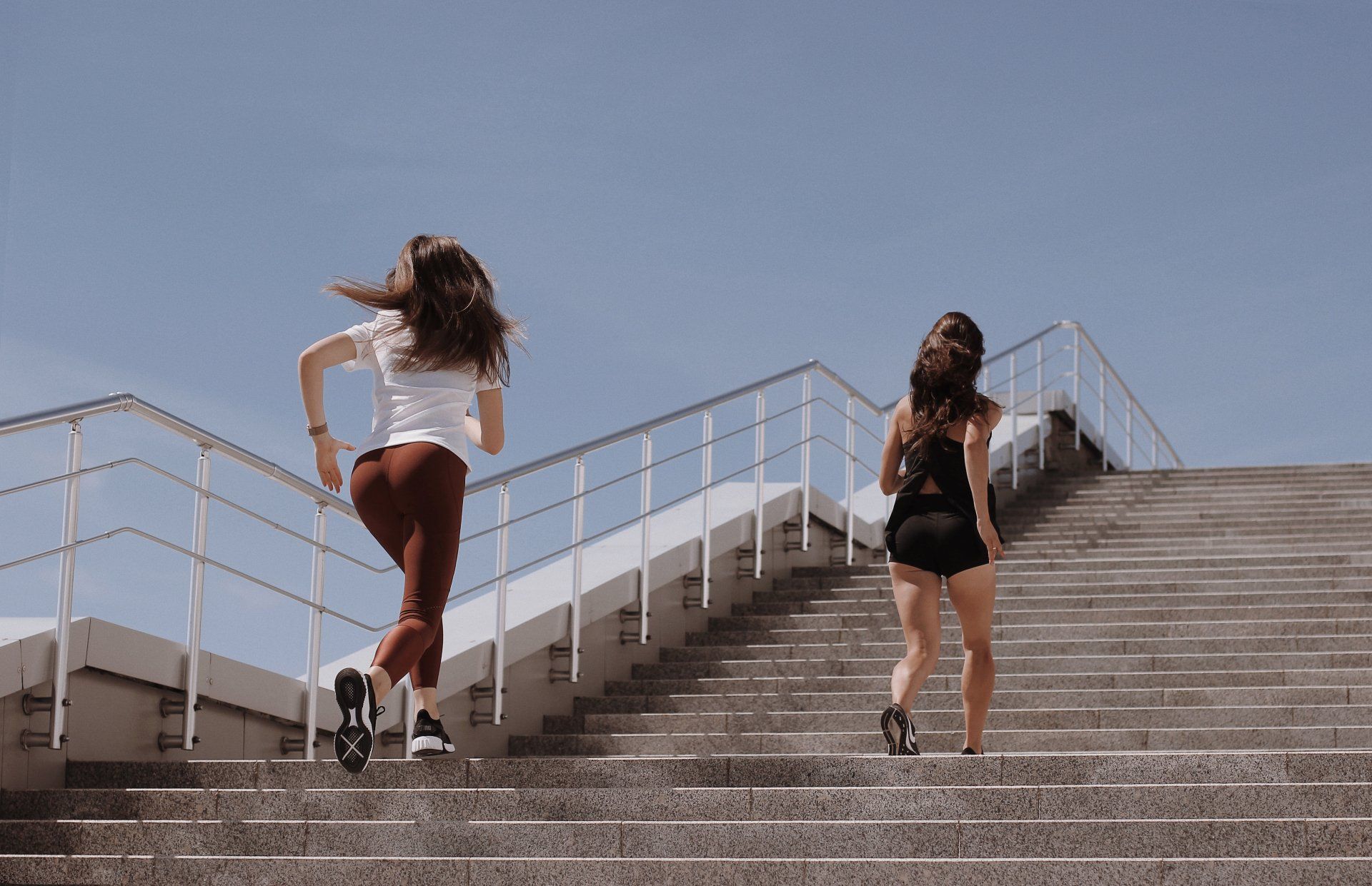 2 woman walking up steps to reach their 10000 goal