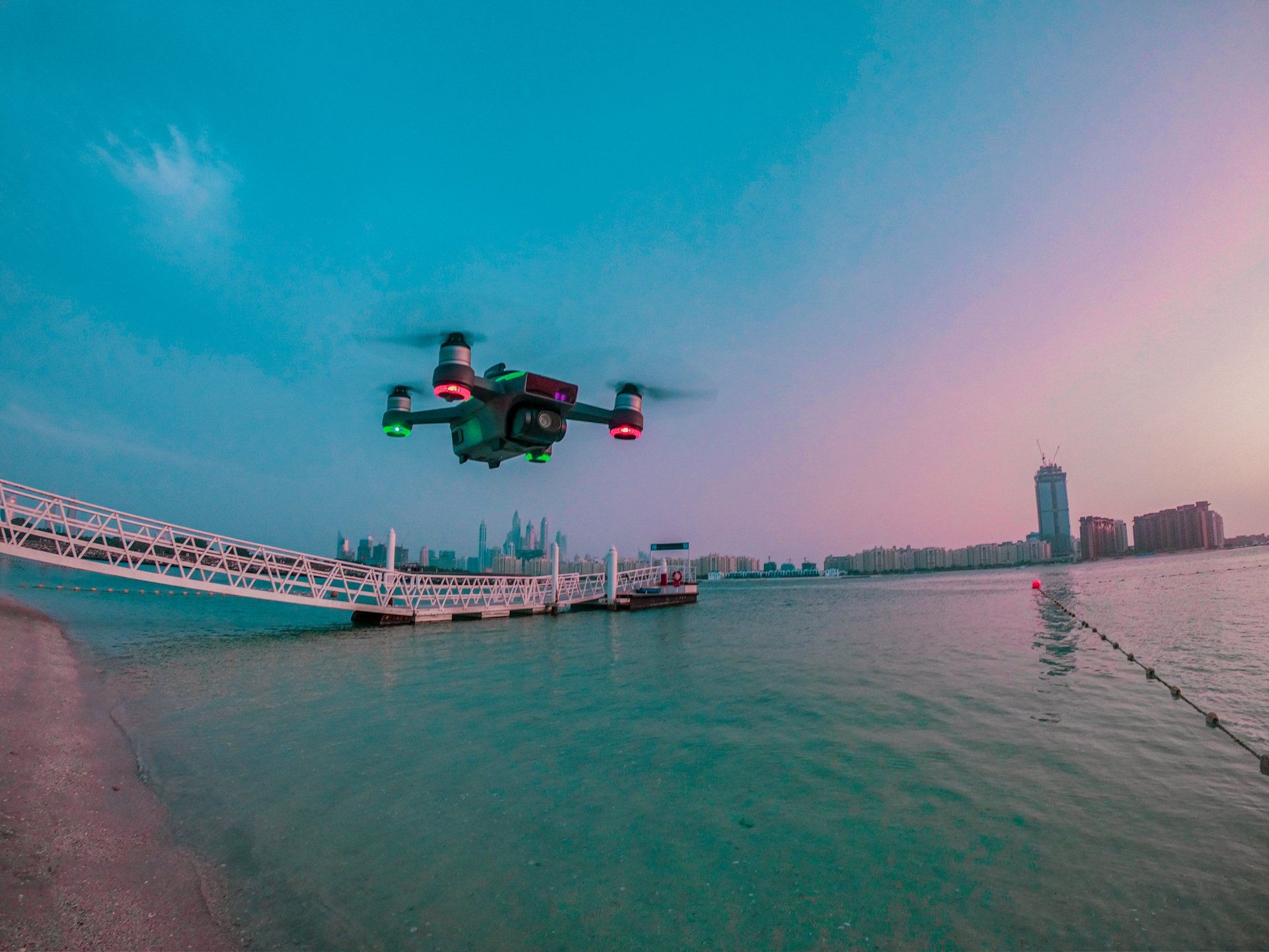 Advanced drone in flight against a clear blue sky, demonstrating superior aerial capabilities for skilled drone pilots.