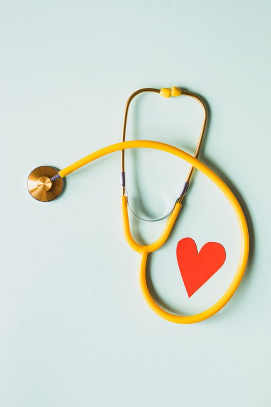 A yellow stethoscope with a red heart on it.