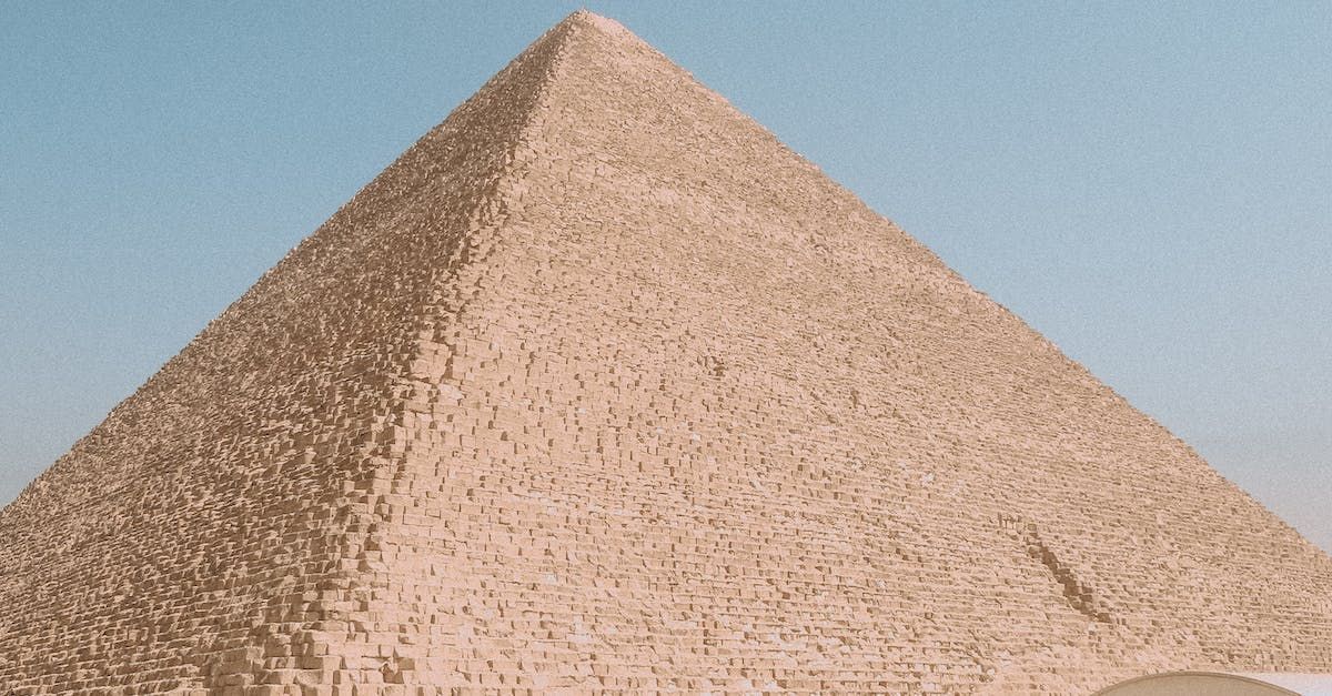 A large pyramid with a blue sky in the background.