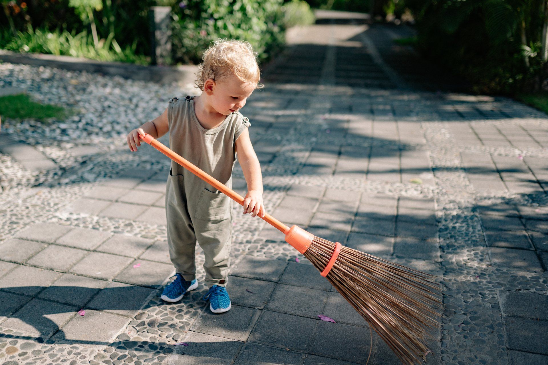 Toddler sweeping with a broom