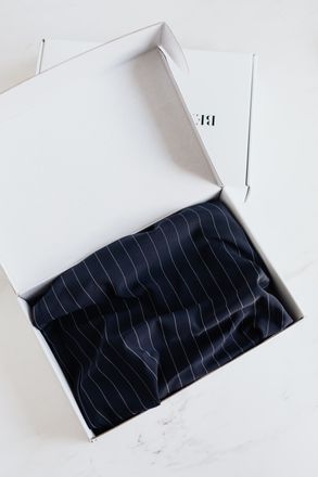 A white box with a black striped fabric inside of it