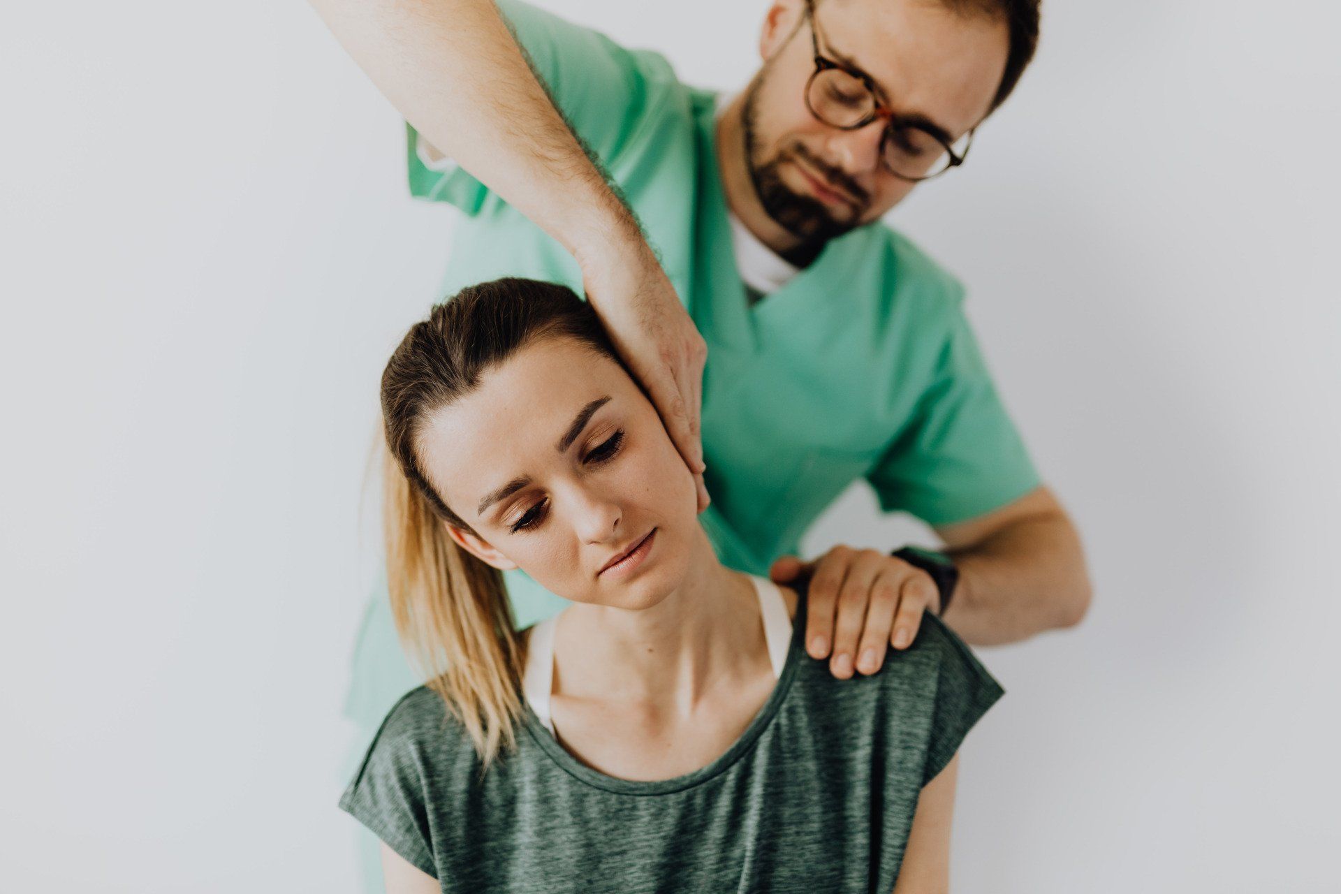 male provider stretching a woman's neck
