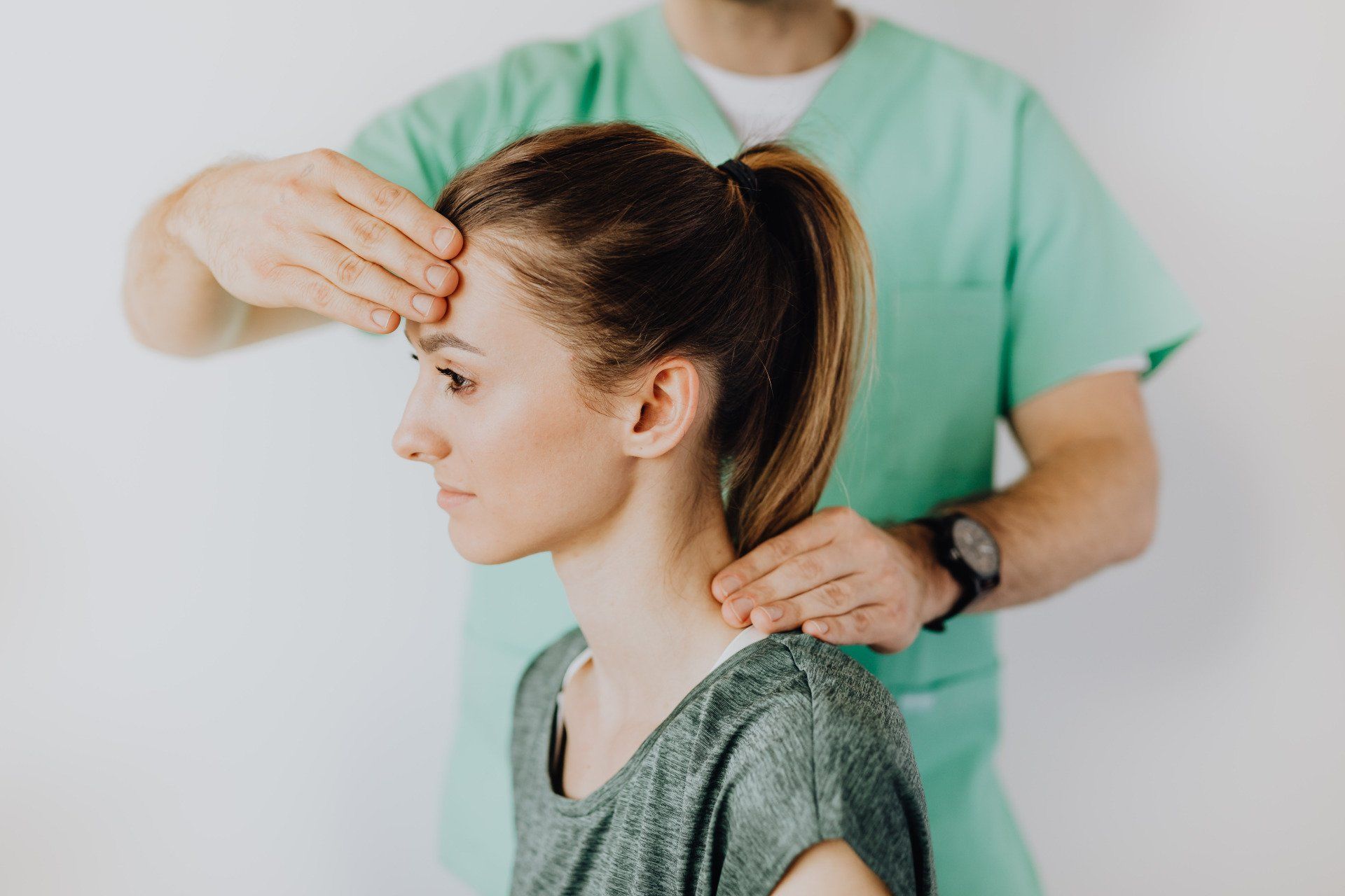 Chiropractor examination of head and neck due to chronic headache complaint.