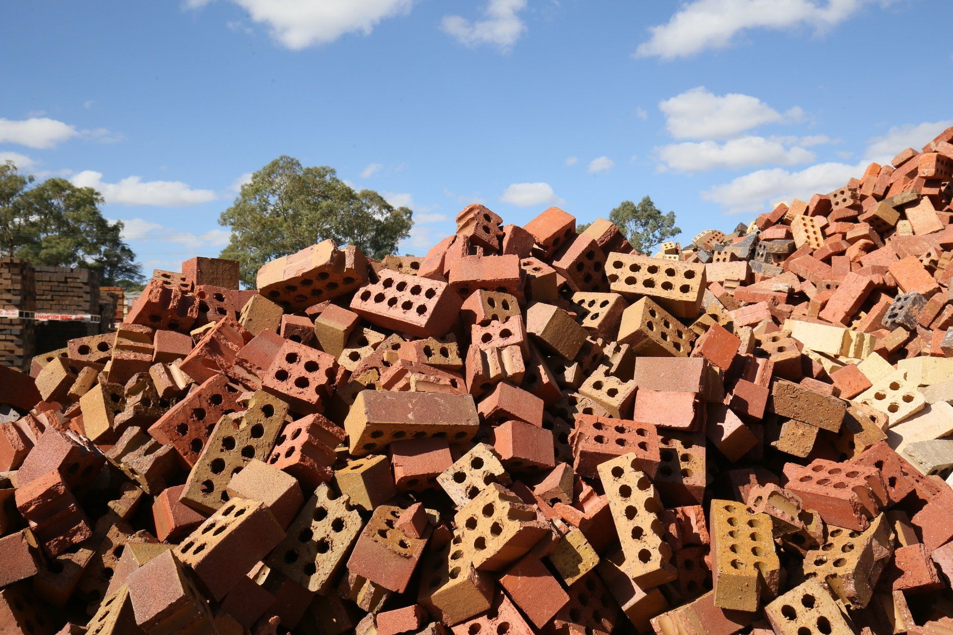 A large pile of red & broken bricks outside