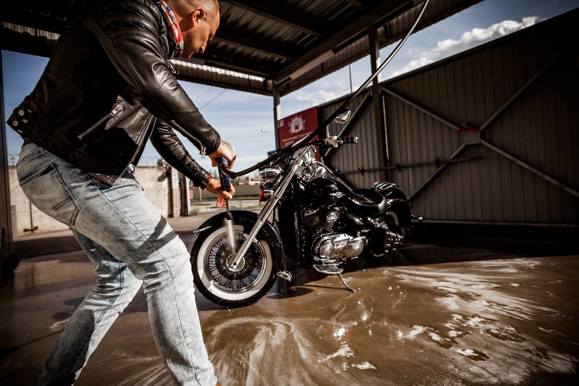 a person cleaning a motorcycle