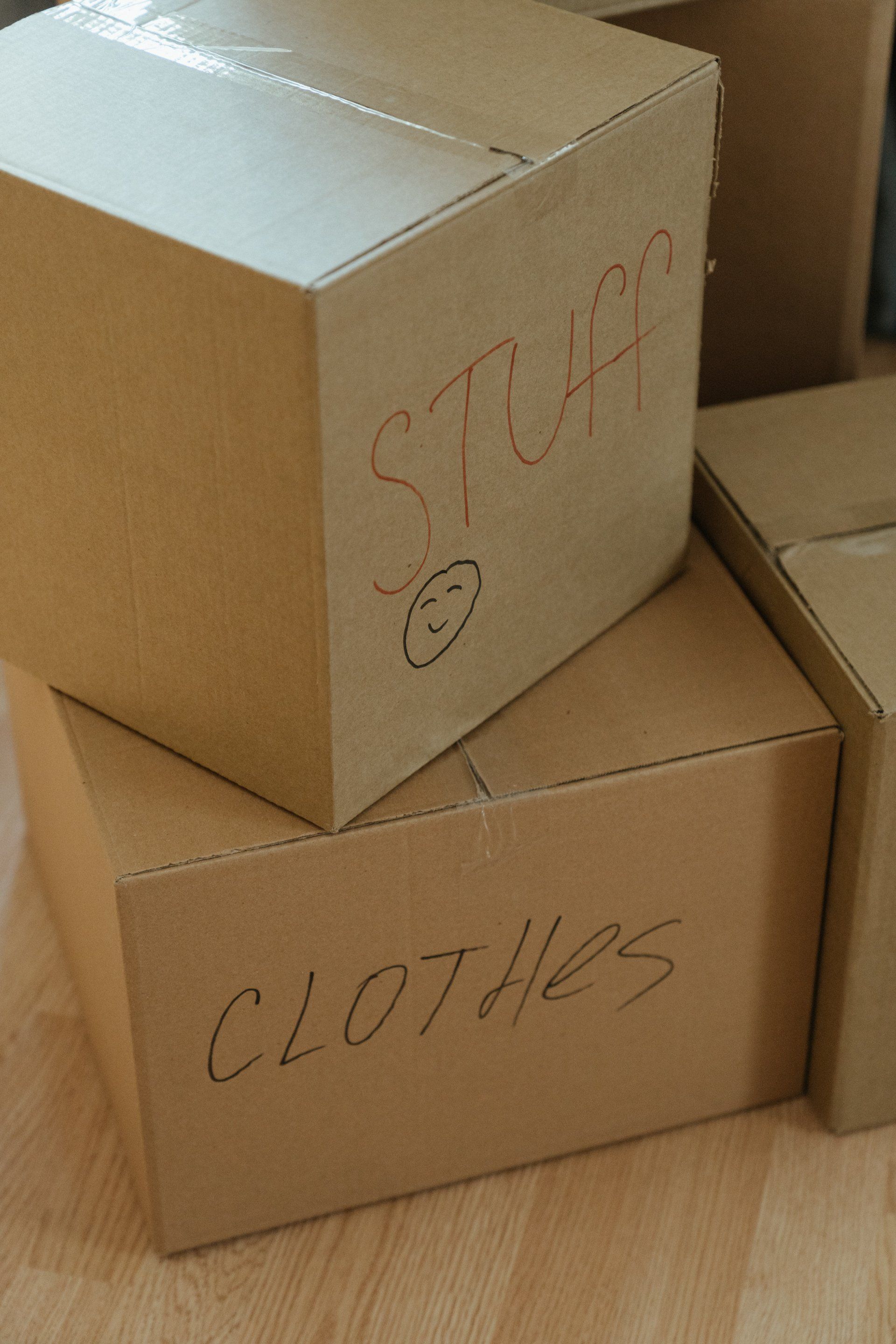 a cardboard box with the word clothes written on it