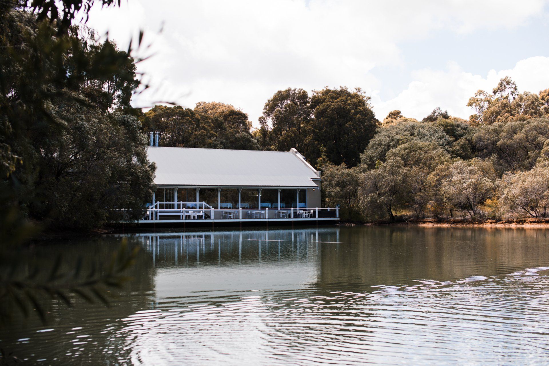 a building sits in the middle of a lake at Tyler State Park