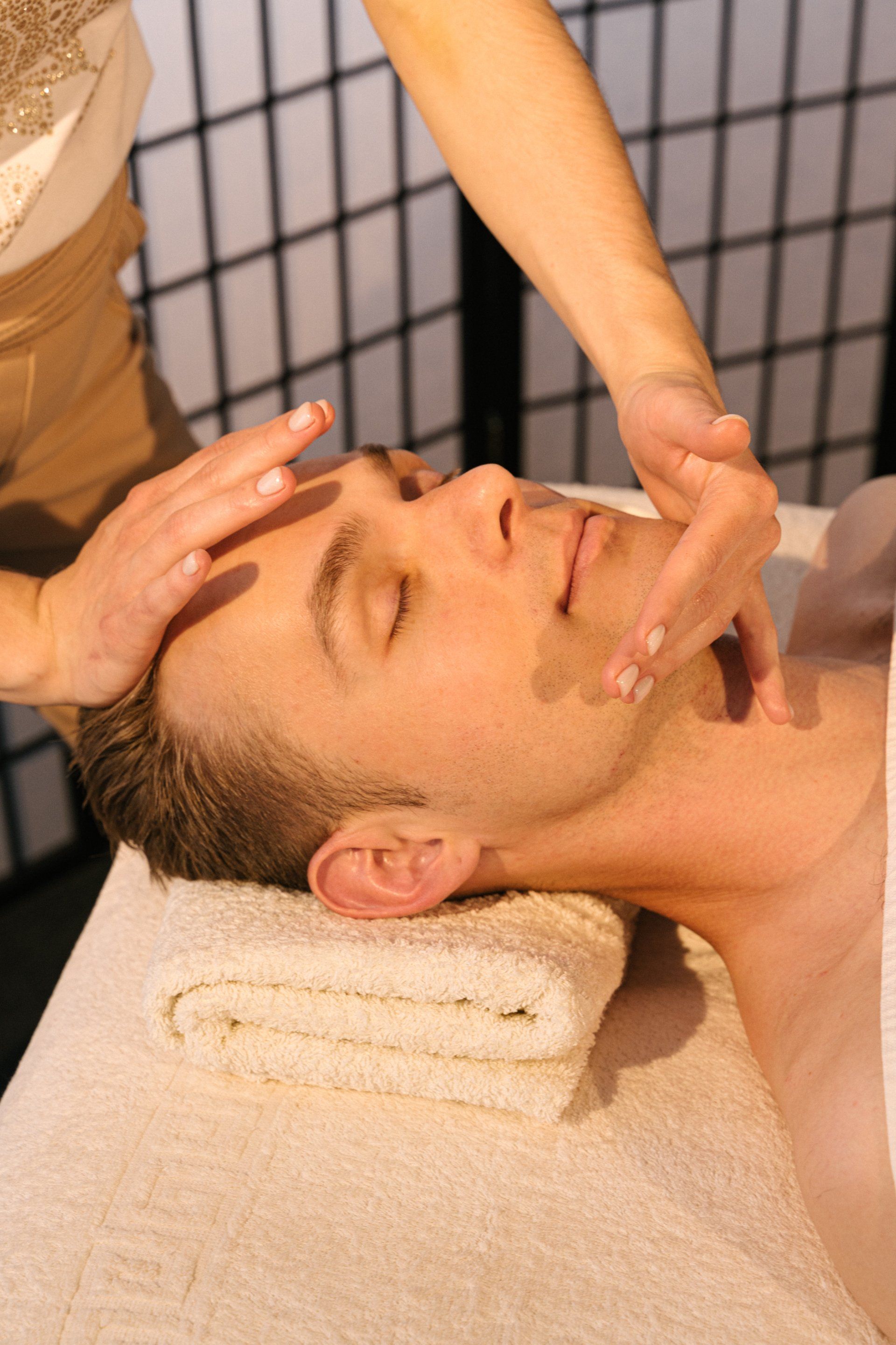 a man is getting a facial massage at a spa