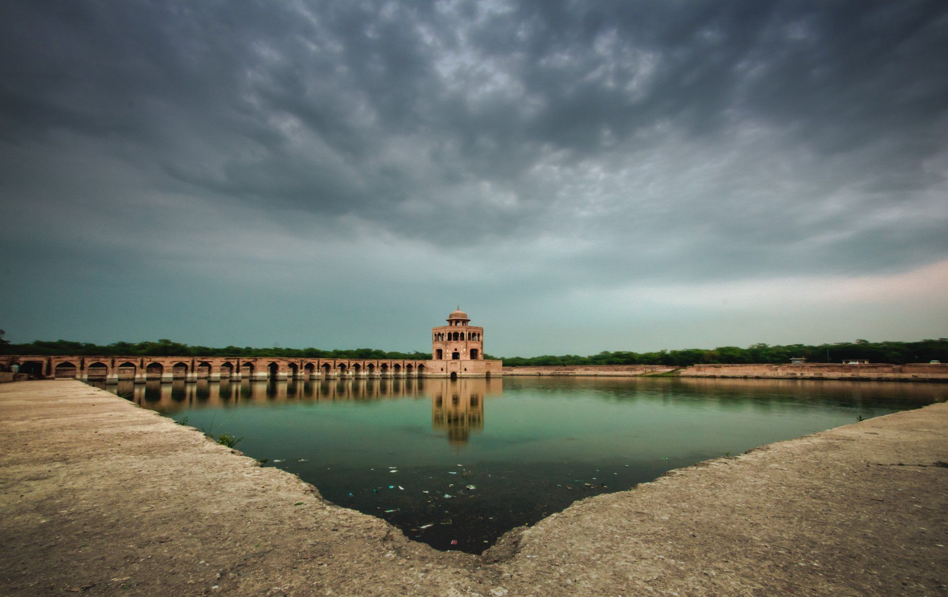 A large body of water with a bridge in the background