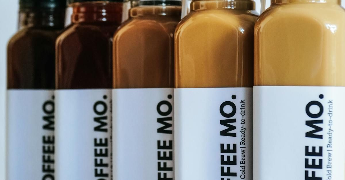 four bottles of coffee mo are lined up in a row